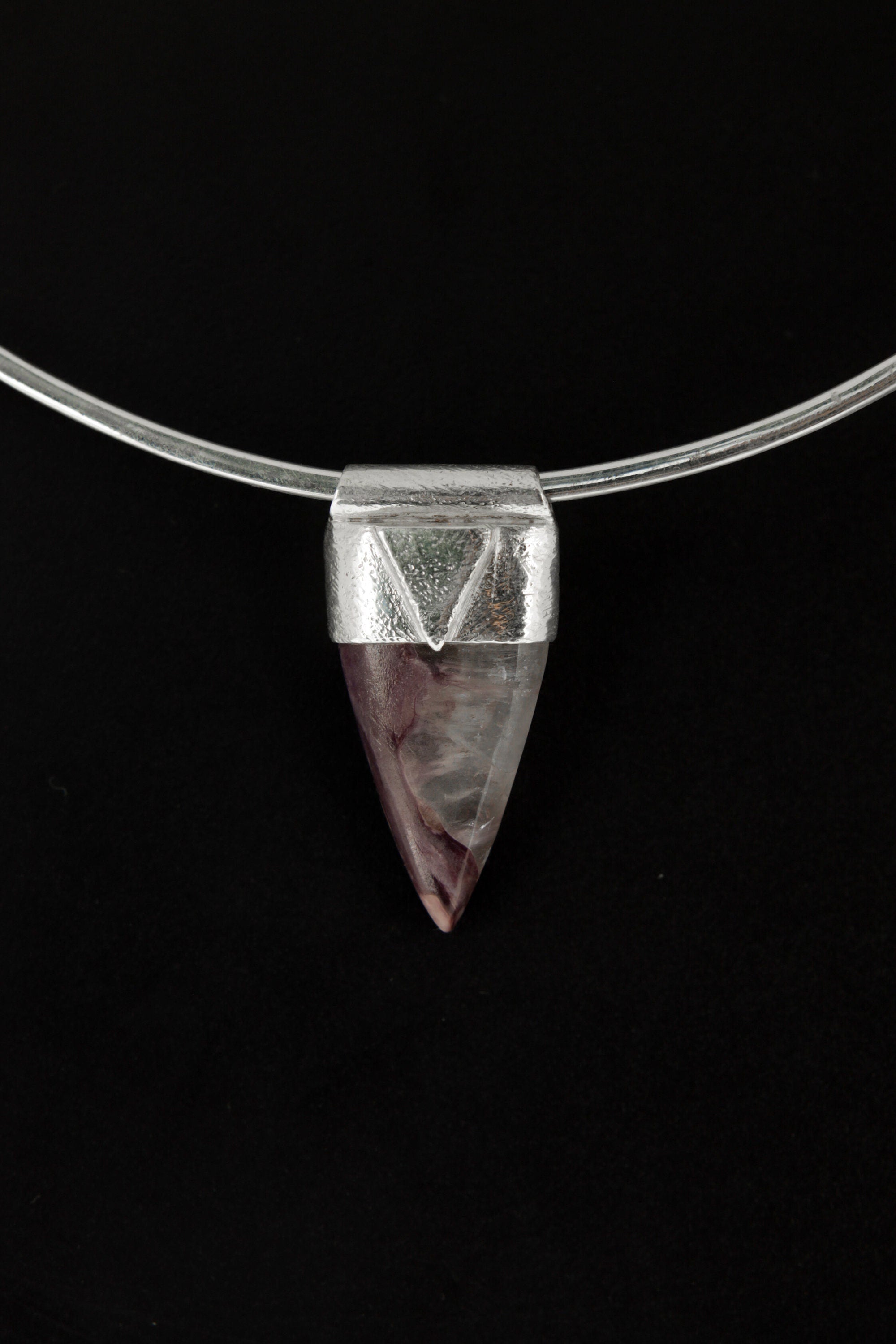 Fang Shaped Charoite Stack Pendant shown on black background with silver choker and purple cabochon body.