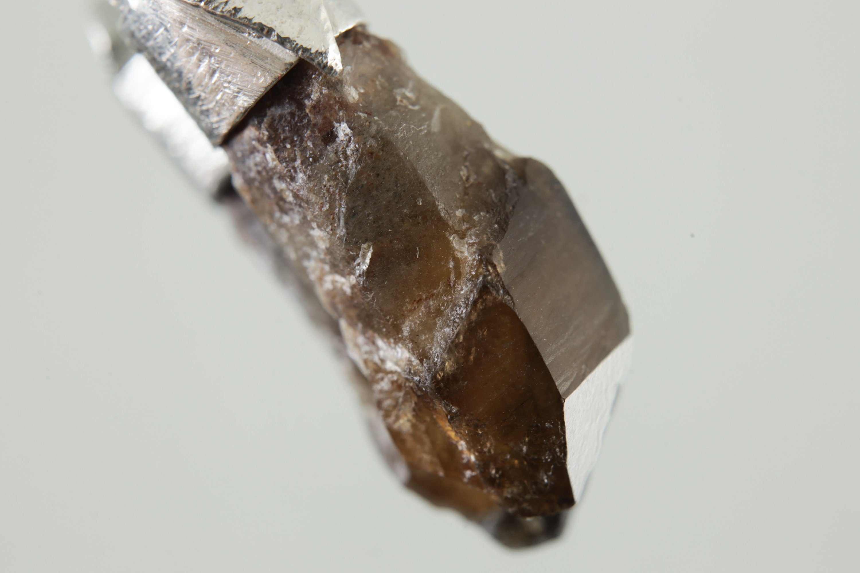 Close-up of Smoky Citrine Phantom Sceptre Quartz showing natural crystal formation, internal layers, and earthy golden tone.