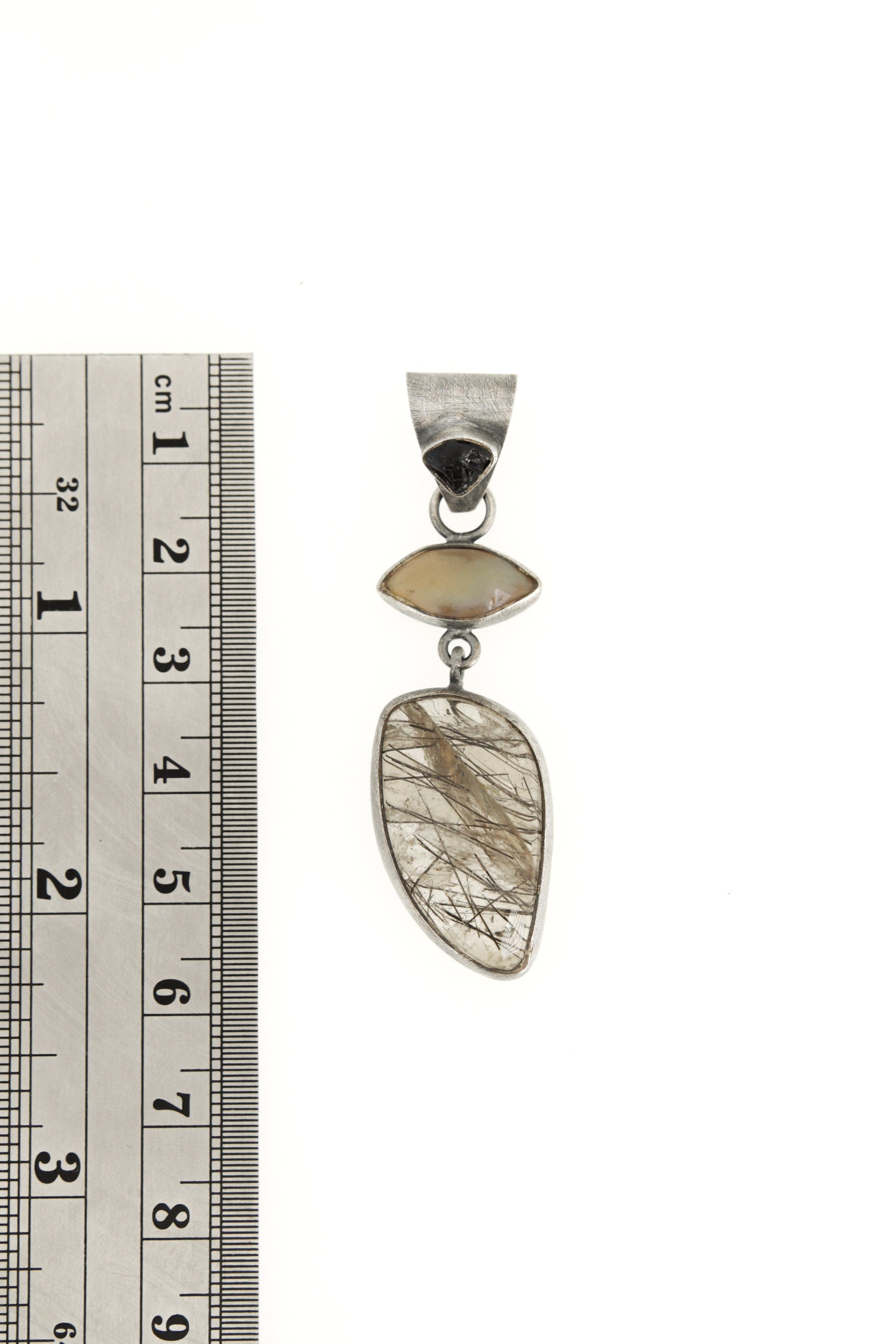 Opal Sapphire Rutile Quartz oxidized silver pendant shown beside a ruler for size reference.