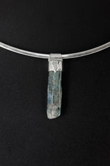 Kyanite Stack Pendant shown on black background with silver choker and slim blue crystal body.