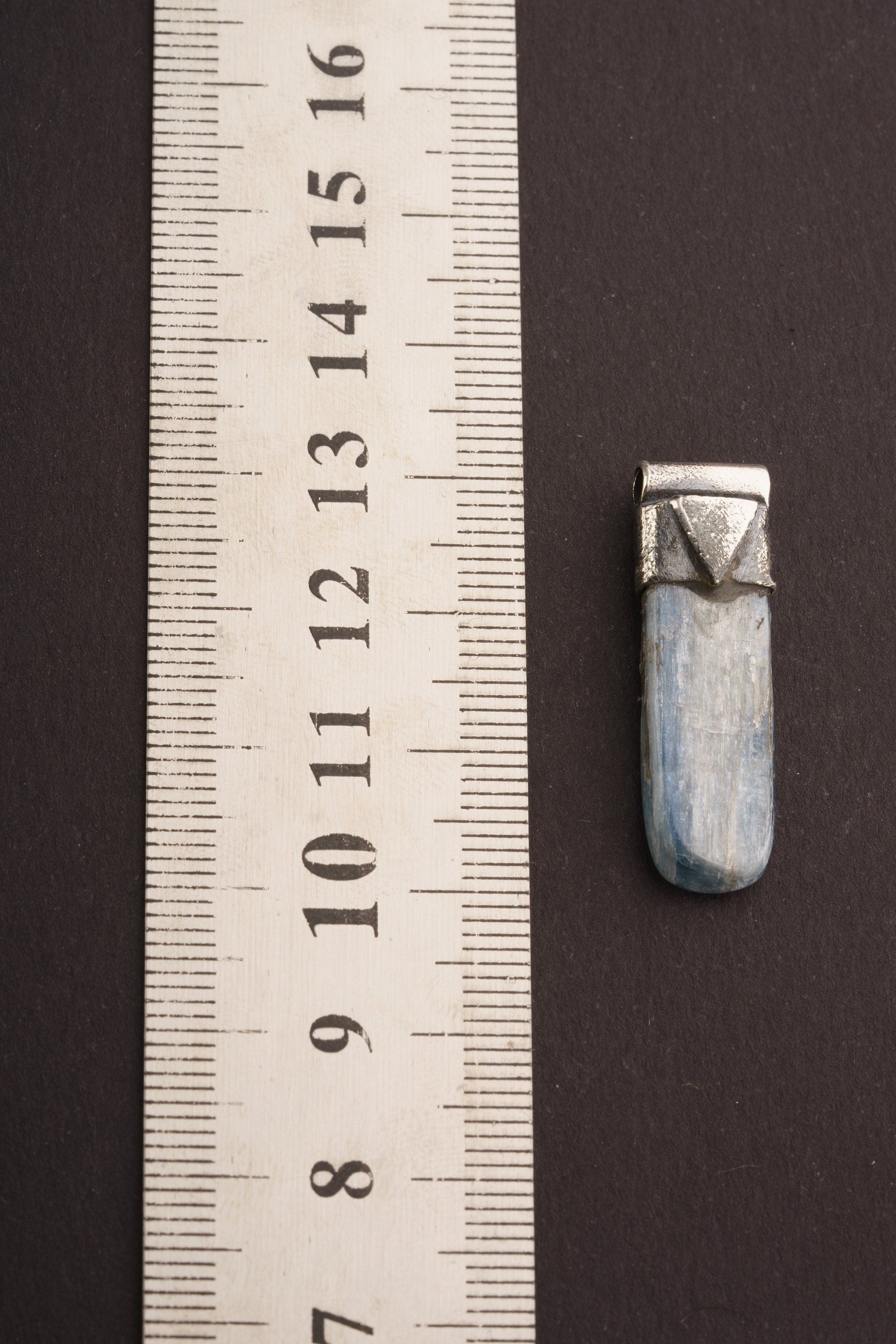 Australian Ocean Kyanite Stack Pendant shown beside a ruler for scale with textured 925 silver cap and polished stone.