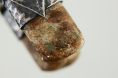Close-up of Brown Dravite Tourmaline showing earthy brown tone, natural crystal texture, and organic silver cap.