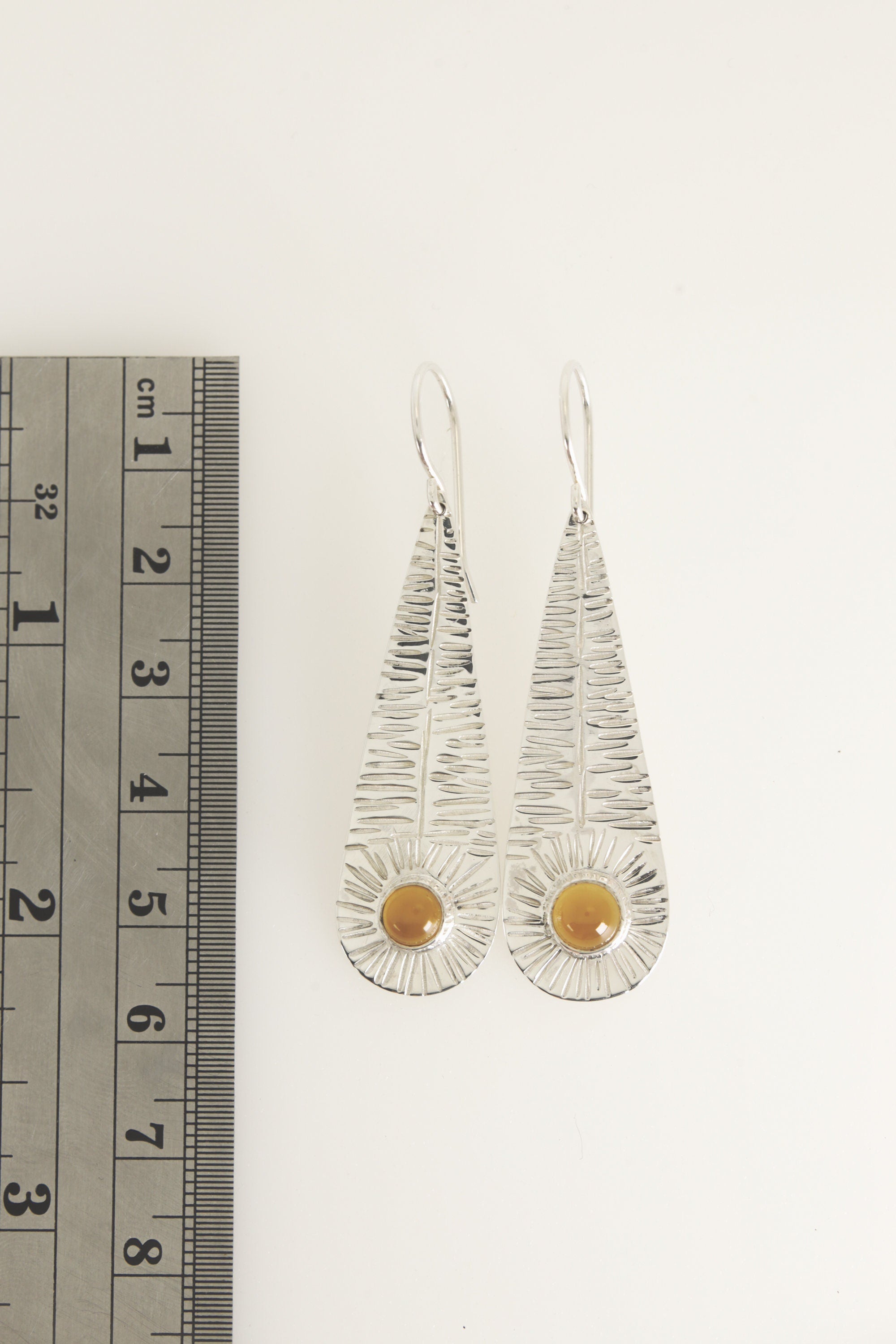 Silver Leaf Agate earrings shown beside a ruler for scale, with long sterling silver leaf shapes and round Orange Agate stones.