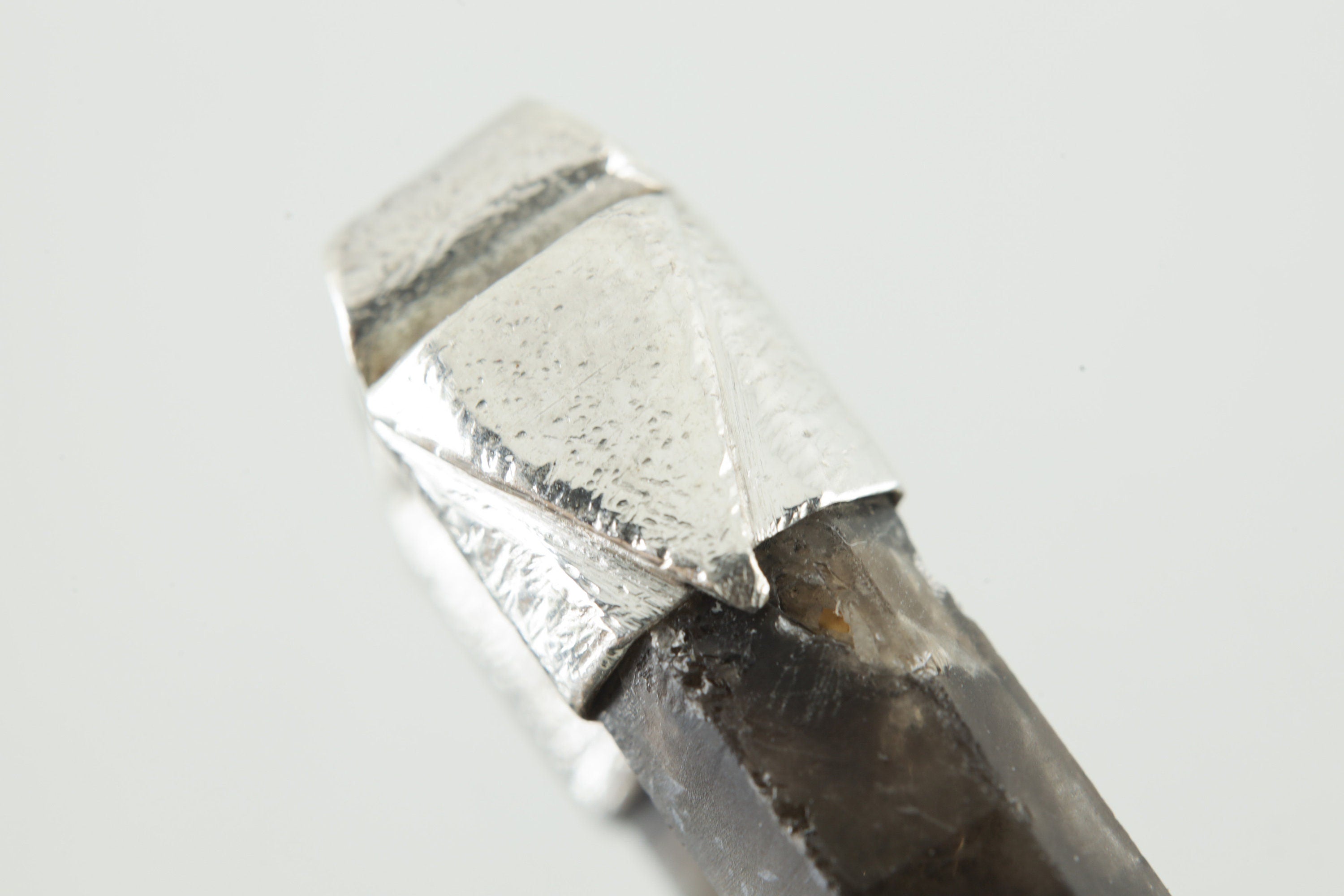 Close-up of Smoky Phantom Window Quartz in a handmade sterling silver Stack Pendant cap with signature triangle detail.
