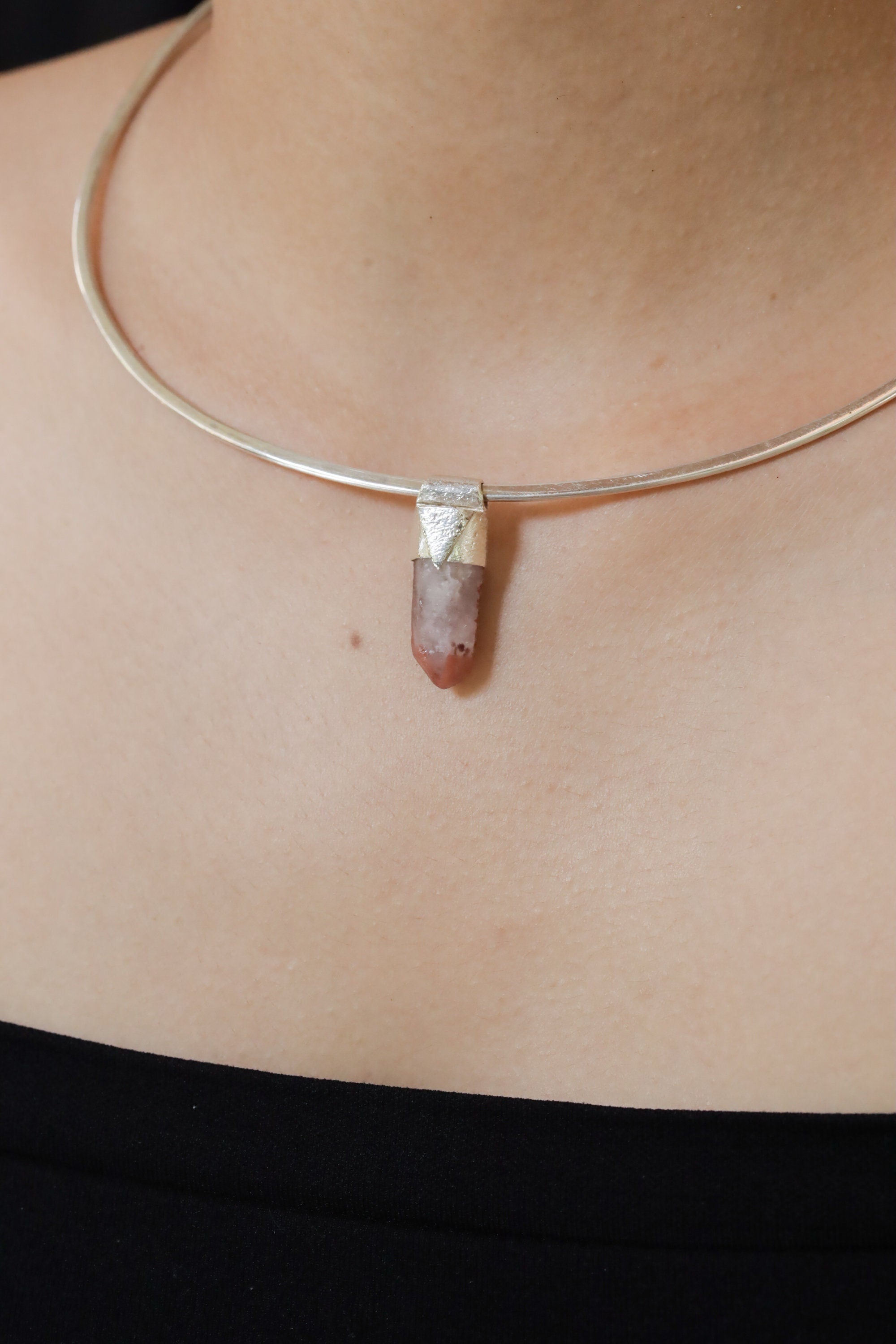 Australian Phantom Lithium Quartz Stack Pendant shown worn on the chest with pale crystal point and silver cap.