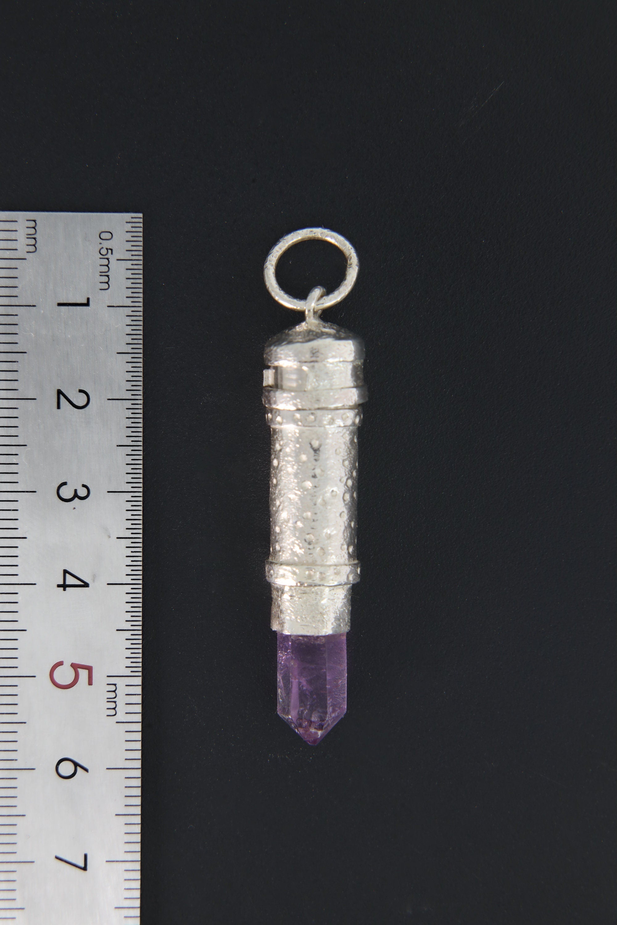 Vera Cruz Amethyst capsule pendant shown beside ruler for approximate size reference.