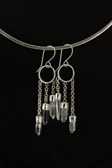 Australian Quartz Point earrings shown on dark background with hammered silver circles and three crystal chain dangles.
