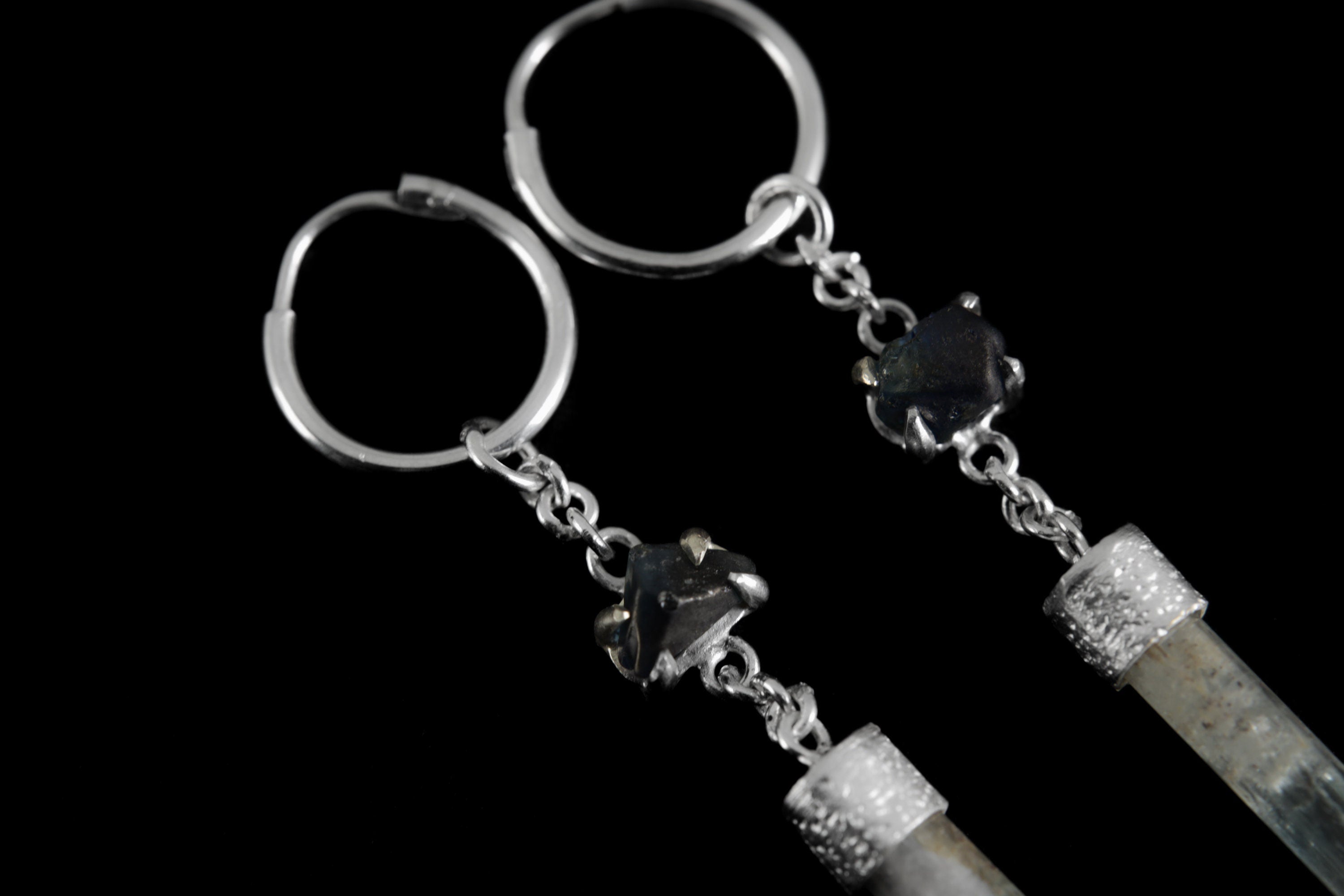Sapphire Aquamarine earrings shown close-up with linked silver rings, blue gemstone accents, and polished sterling silver.