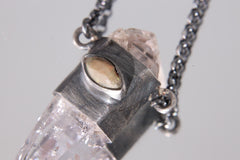 Close-up of Cat’s Eye Ethiopian Opal set into oxidized sterling silver beside Double Terminated Vera Cruz Amethyst.