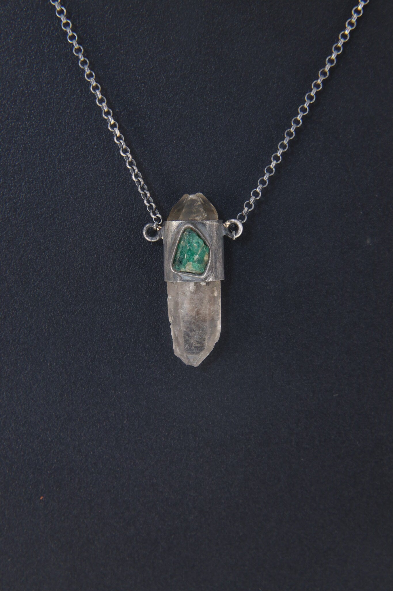 Vera Cruz Amethyst Emerald Pendant shown on dark background with oxidized silver chain and vertical crystal drop.