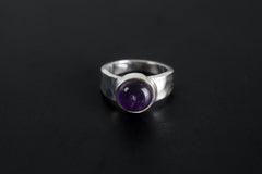 Harmonious Amethyst Essence Ring shown on black background with round purple Amethyst and polished sterling silver band.