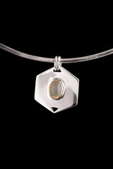 Ethiopian Opal hexagon pendant displayed on a choker against dark background with polished silver frame.