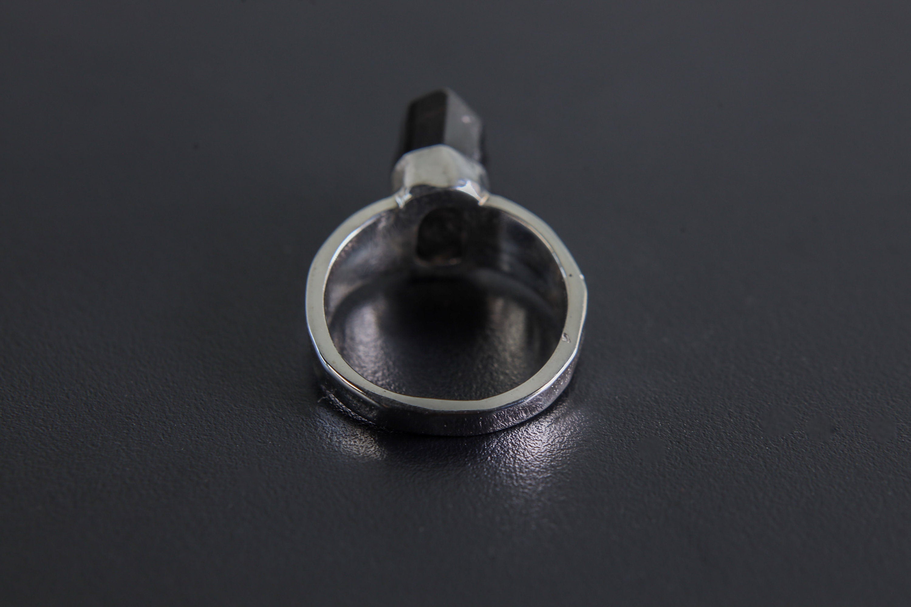 Back view of Black Tourmaline sterling silver ring showing the circular band and handmade hammered silver texture.