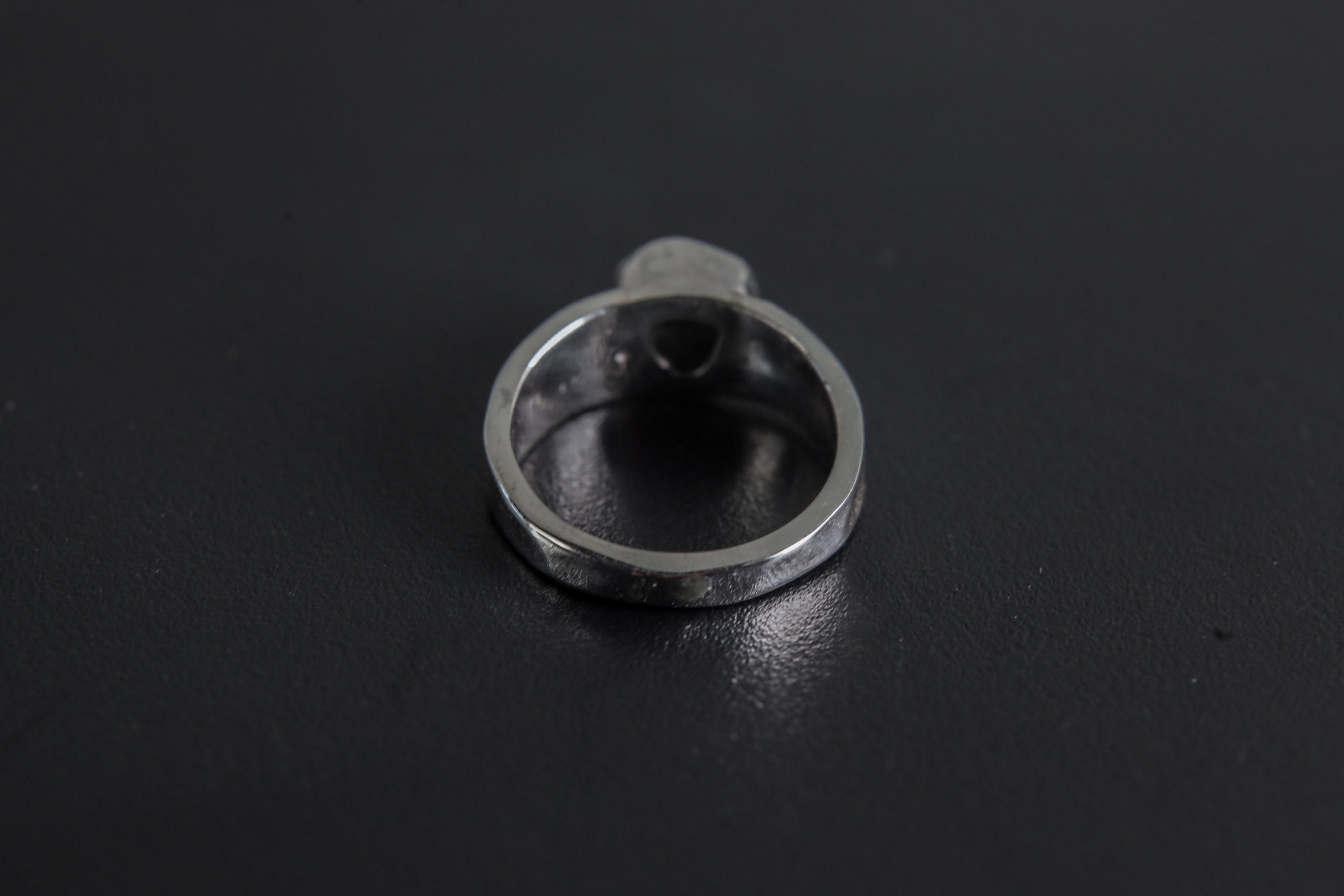 Back view of Black Tourmaline sterling silver ring showing the circular band and handmade hammered silver texture.