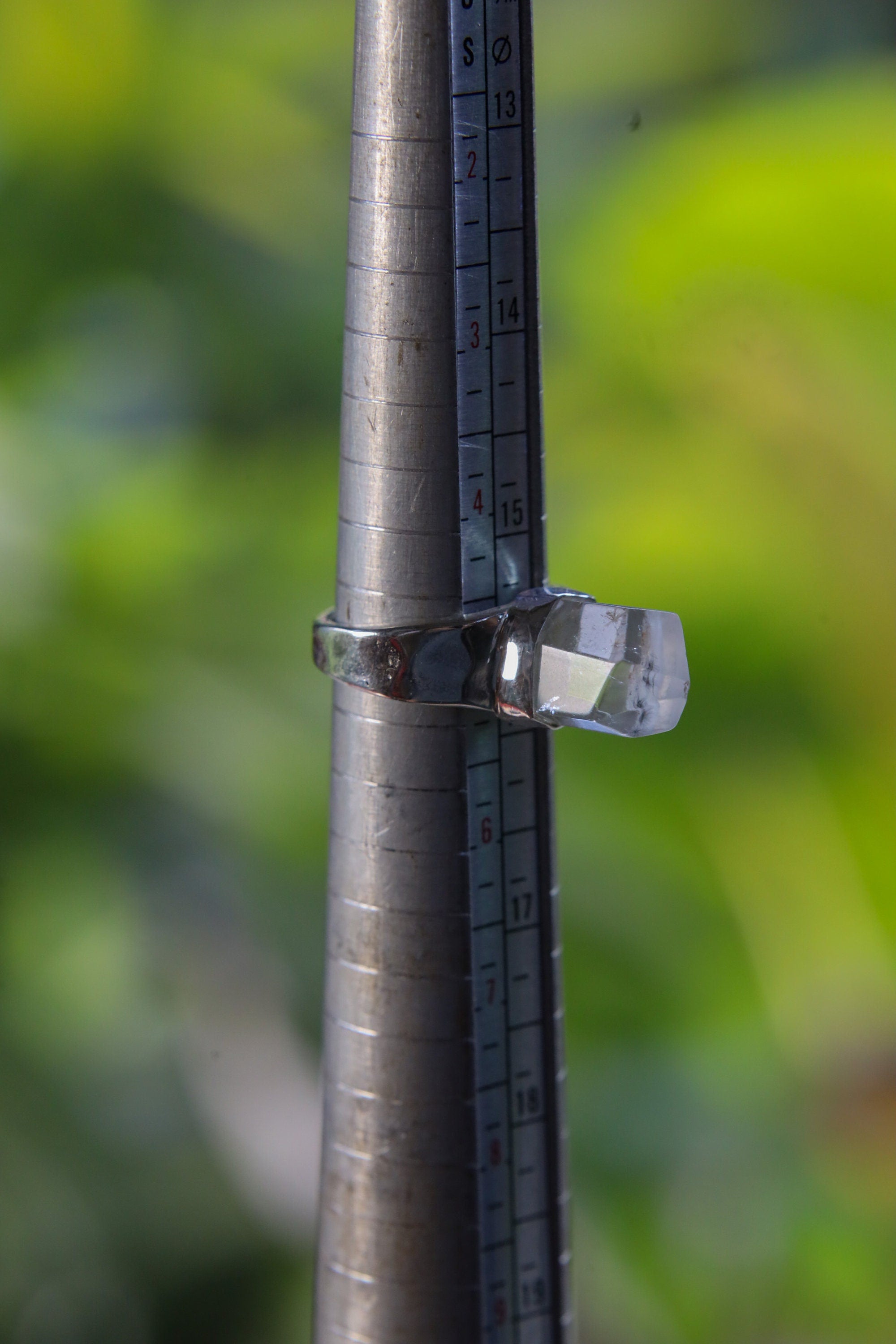 Cacoxenite Quartz sterling silver ring shown on a mandrel for size reference, appearing around US size 6 to 6.5.