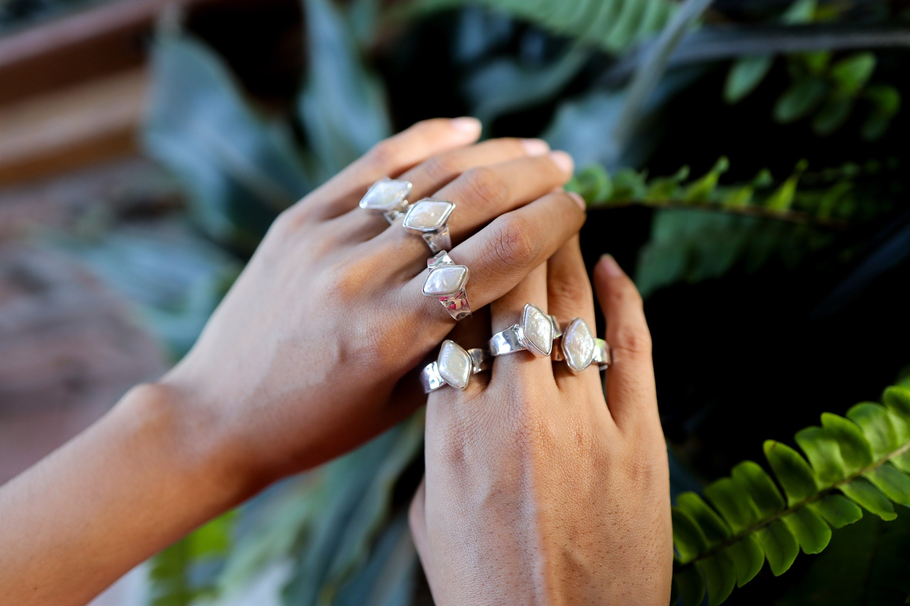 Lunar Gleam Marquise Pearl Ring shown worn outdoors with soft Pearl lustre and textured sterling silver band.