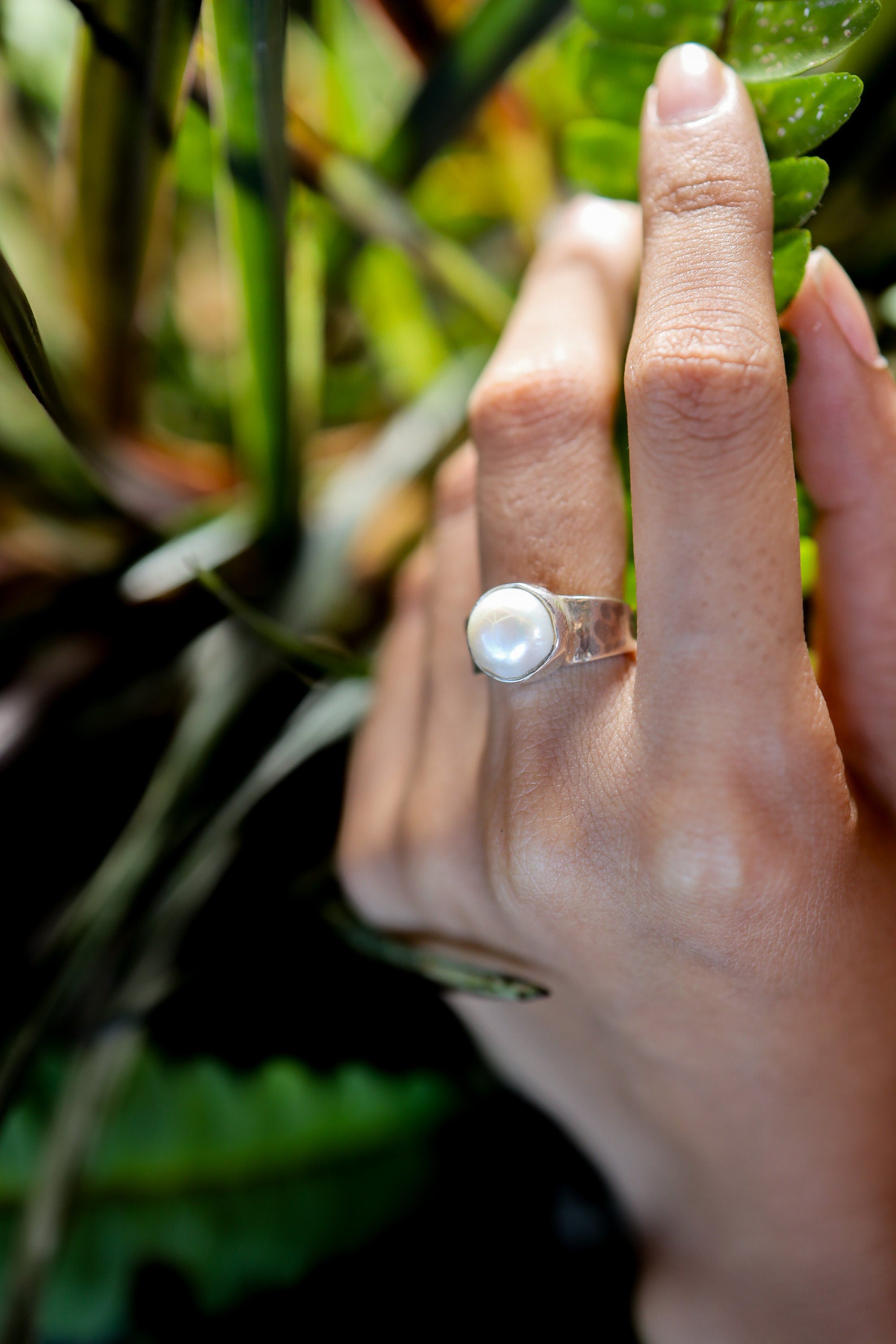 Lunar Luster Pearl Ring shown worn outdoors with round Pearl and hammered 925 silver texture.