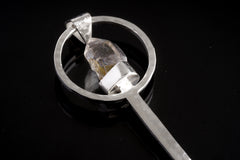 Close-up of Vera Cruz Amethyst spoon pendant showing oxidized hammered silver texture and pale purple crystal.