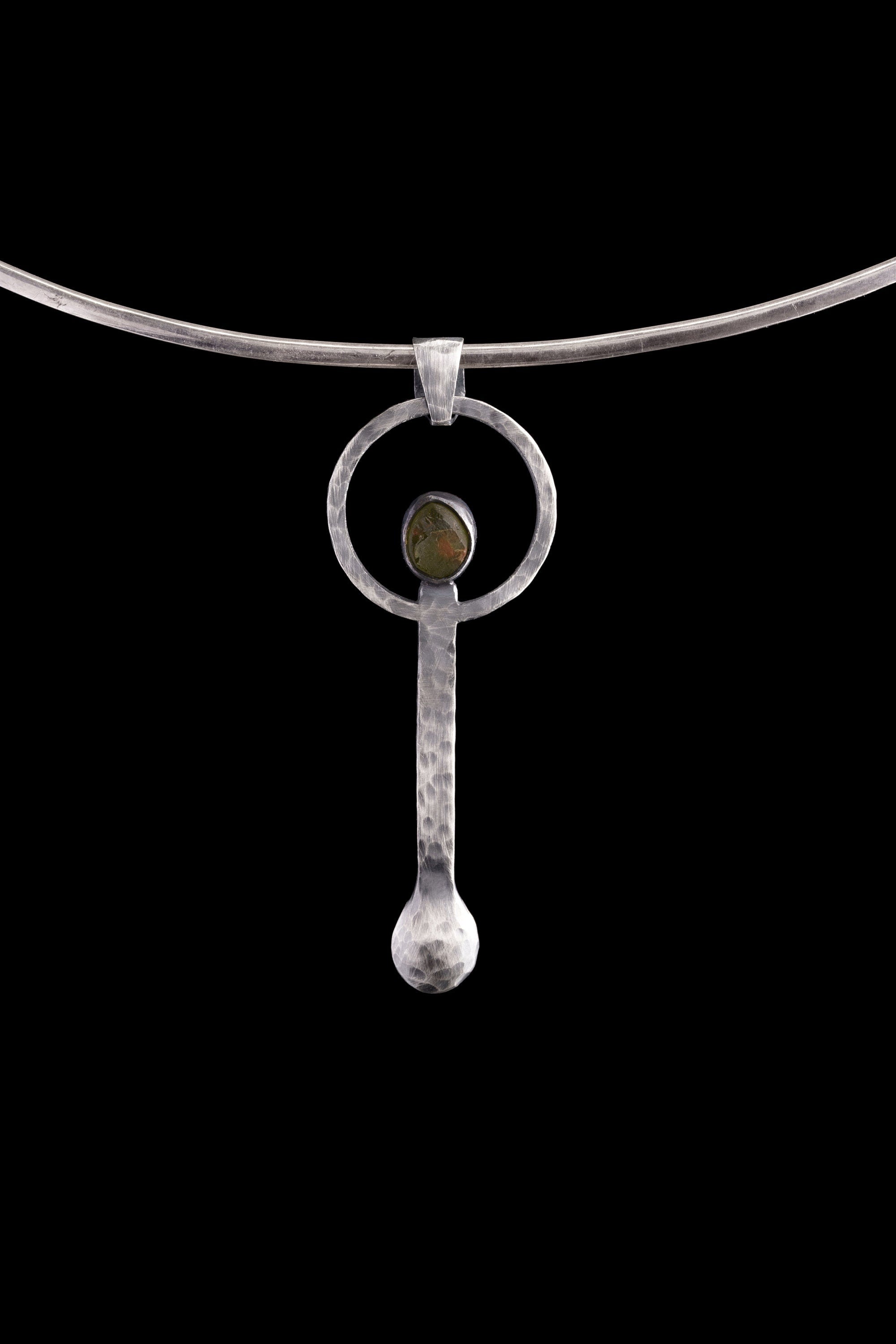 Peridot oxidized sterling silver ritual spoon shown on a choker with dark background and handmade spoon form.