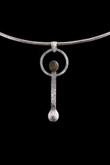 Peridot oxidized sterling silver ritual spoon shown on a choker with dark background and handmade spoon form.