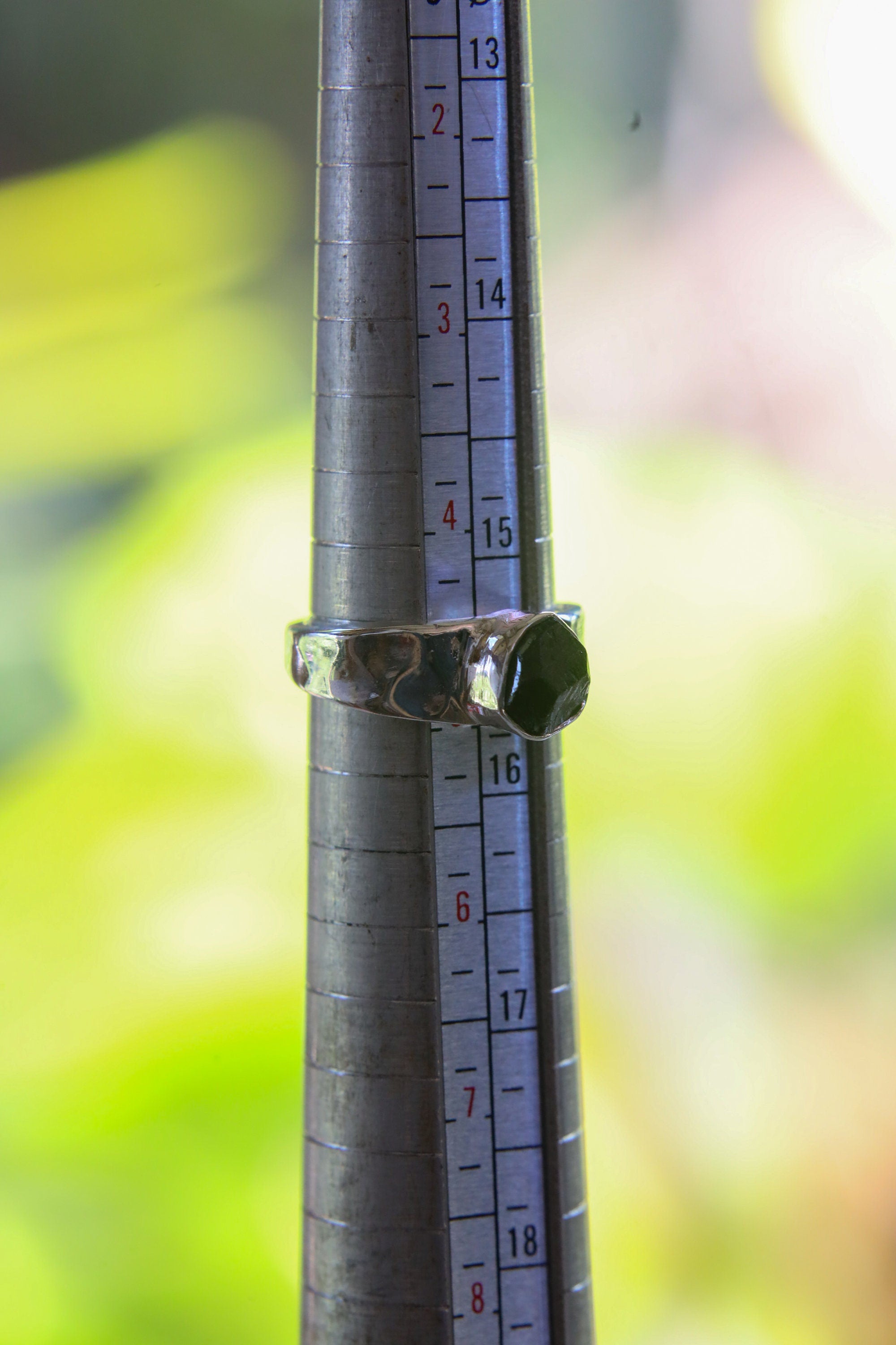 Black Tourmaline sterling silver ring shown on a mandrel for size reference, appearing around US size 6.5 to 7.