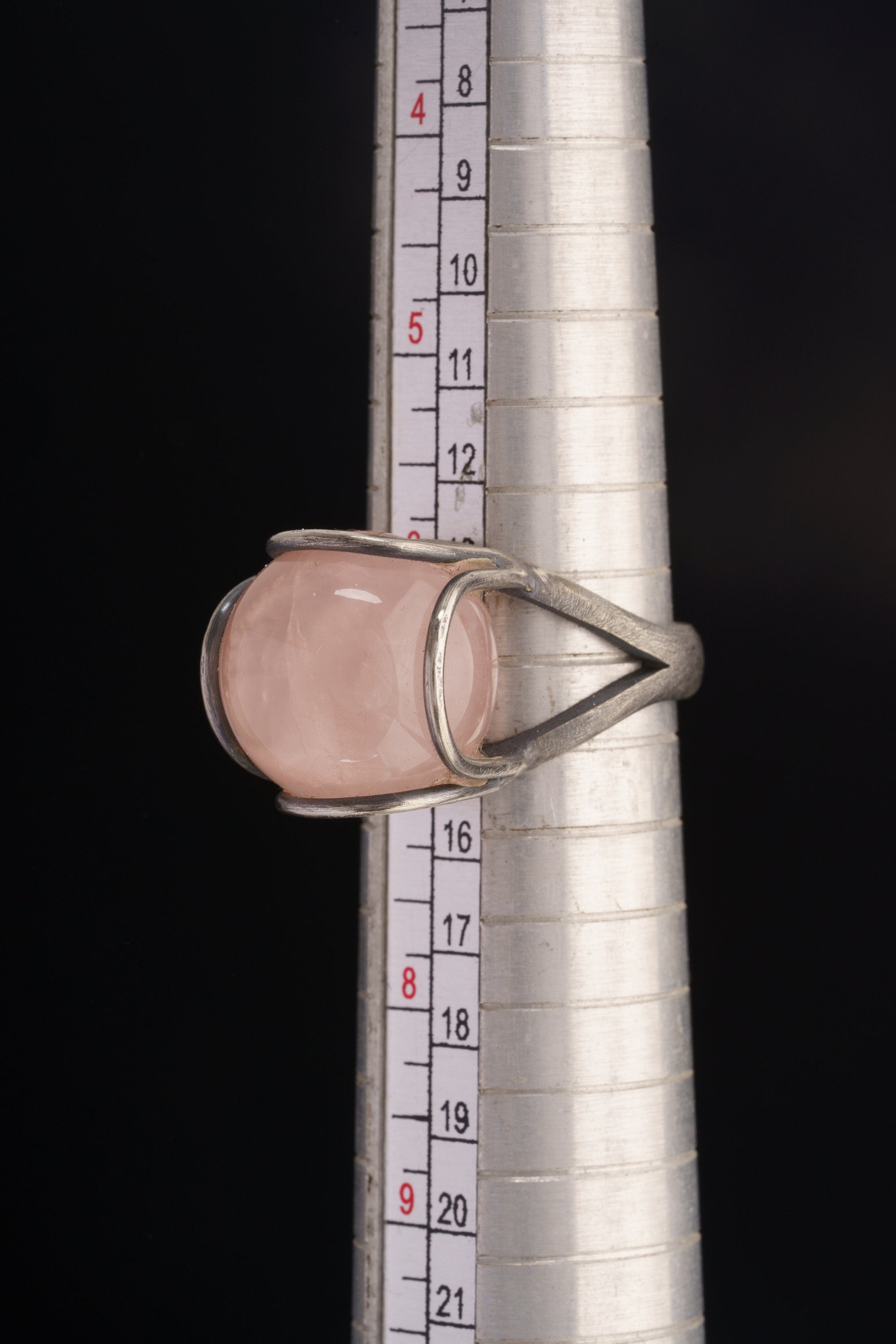 Rose Quartz Floral Silver Ring shown beside a ruler for scale with organic silver wire setting and pink stone.