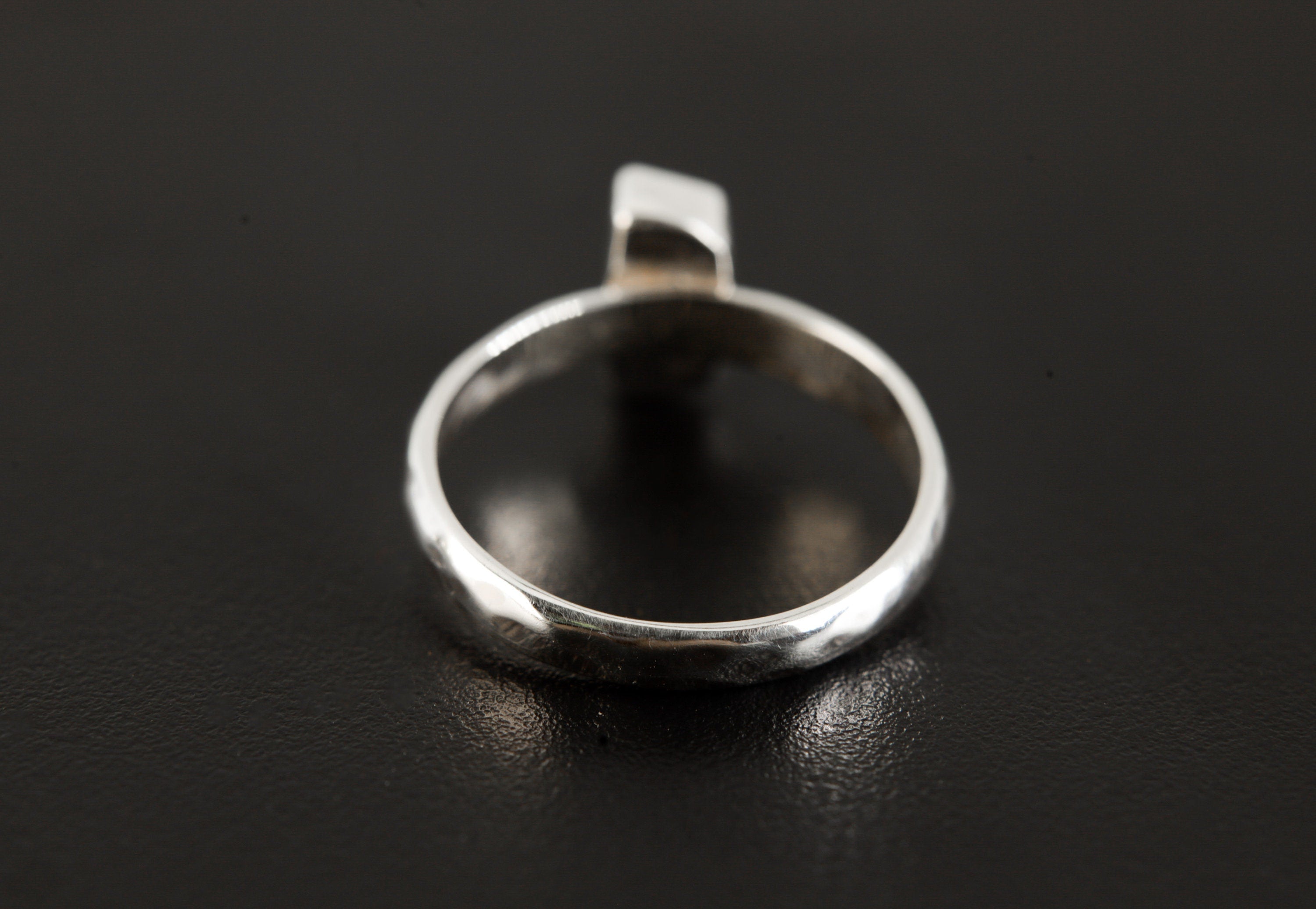 Back view of Green Tourmaline sterling silver ring showing handmade hammered band and polished silver profile.
