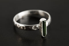 Side view of Green Tourmaline silver ring showing hammered sterling silver band and slim vertical gemstone setting.