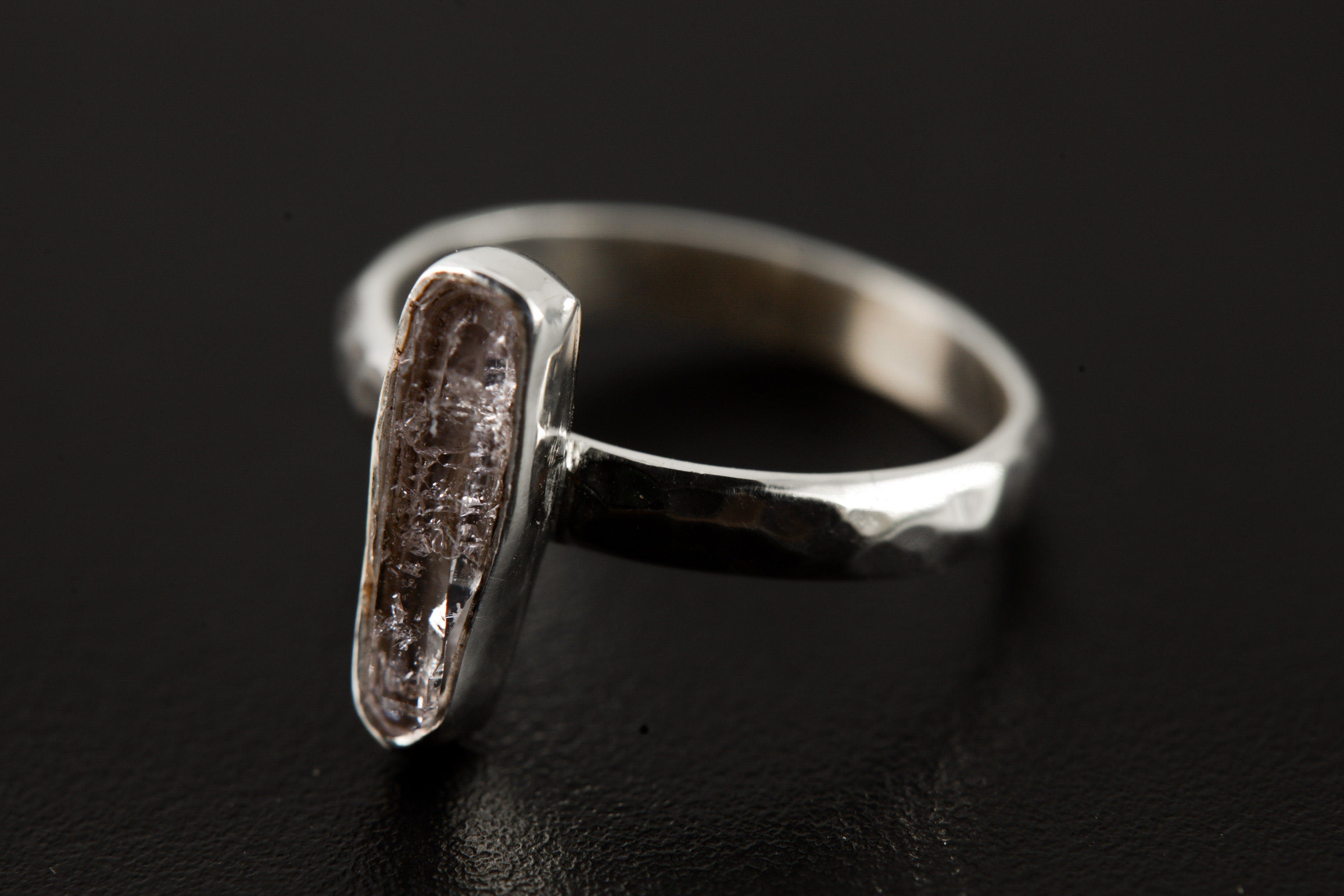Side view of Vera Cruz Amethyst ring with high-shine 925 silver band, hammered texture, and raised crystal setting.