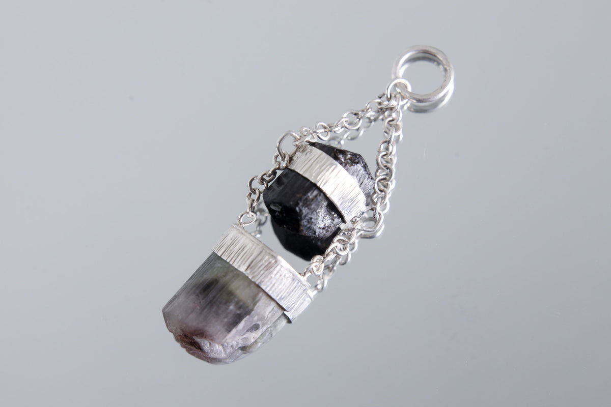 Black Tourmaline Watermelon Tourmaline pendant shown on a light background with polished sterling silver and specialty chain.