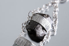 Close-up of Black Tourmaline and Watermelon Tourmaline stones in polished sterling silver with specialty chain detail.