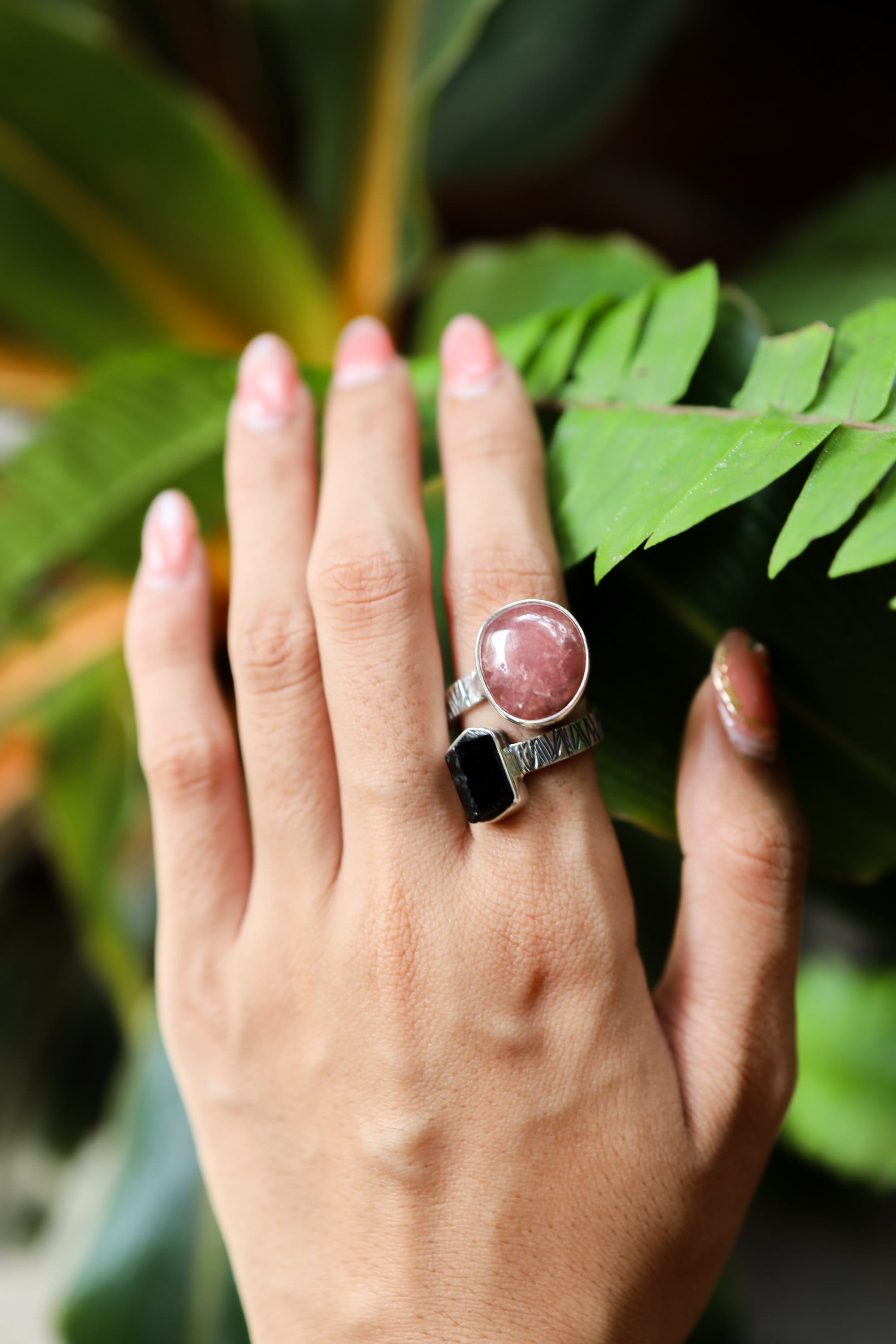 Dravite Tourmaline Sunstone ring shown worn outdoors, with warm solar stone contrast and oxidized sterling silver band.