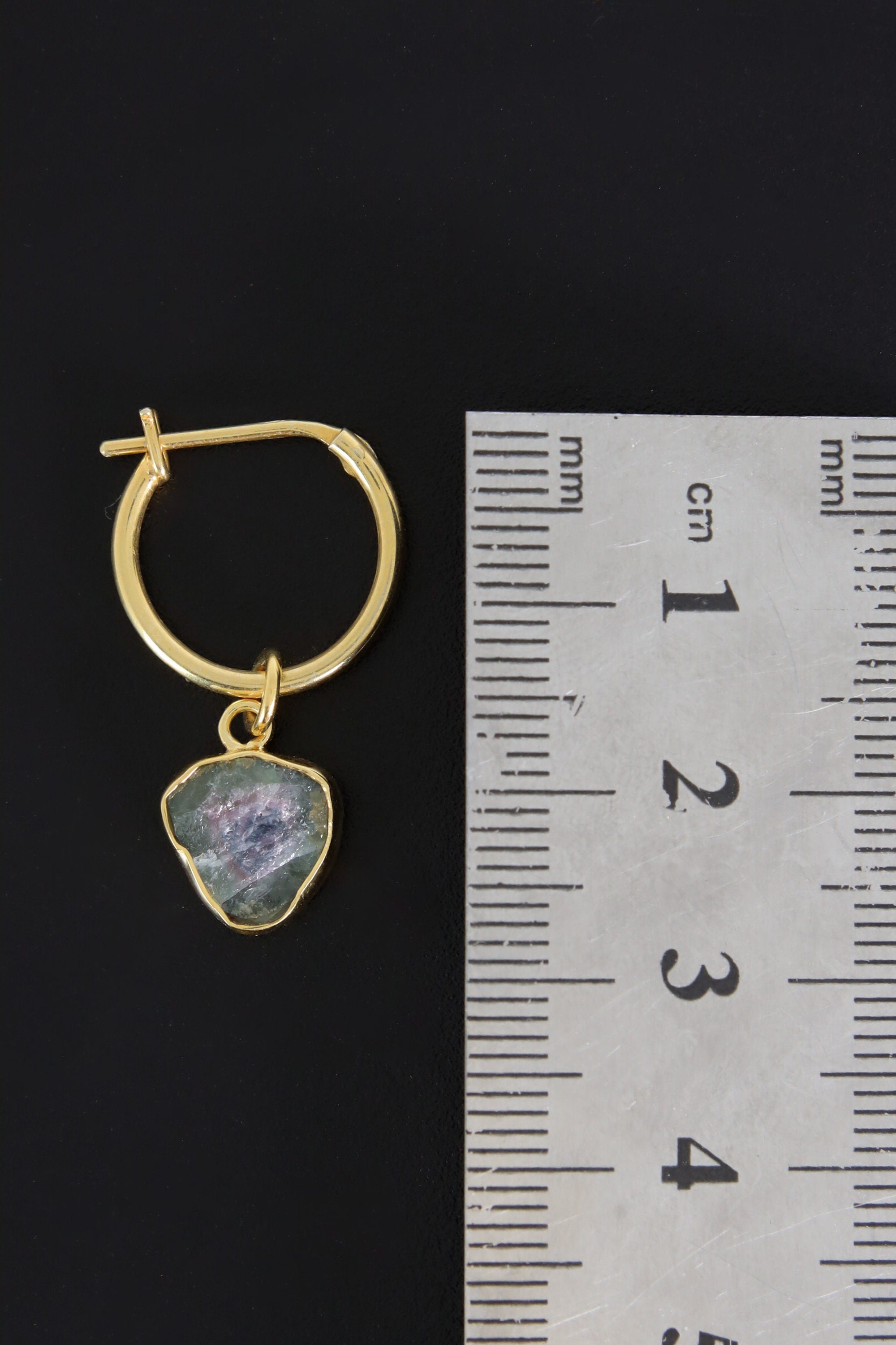 Watermelon Tourmaline gold-plated hoop earring pendant shown beside a ruler for scale as one single piece.