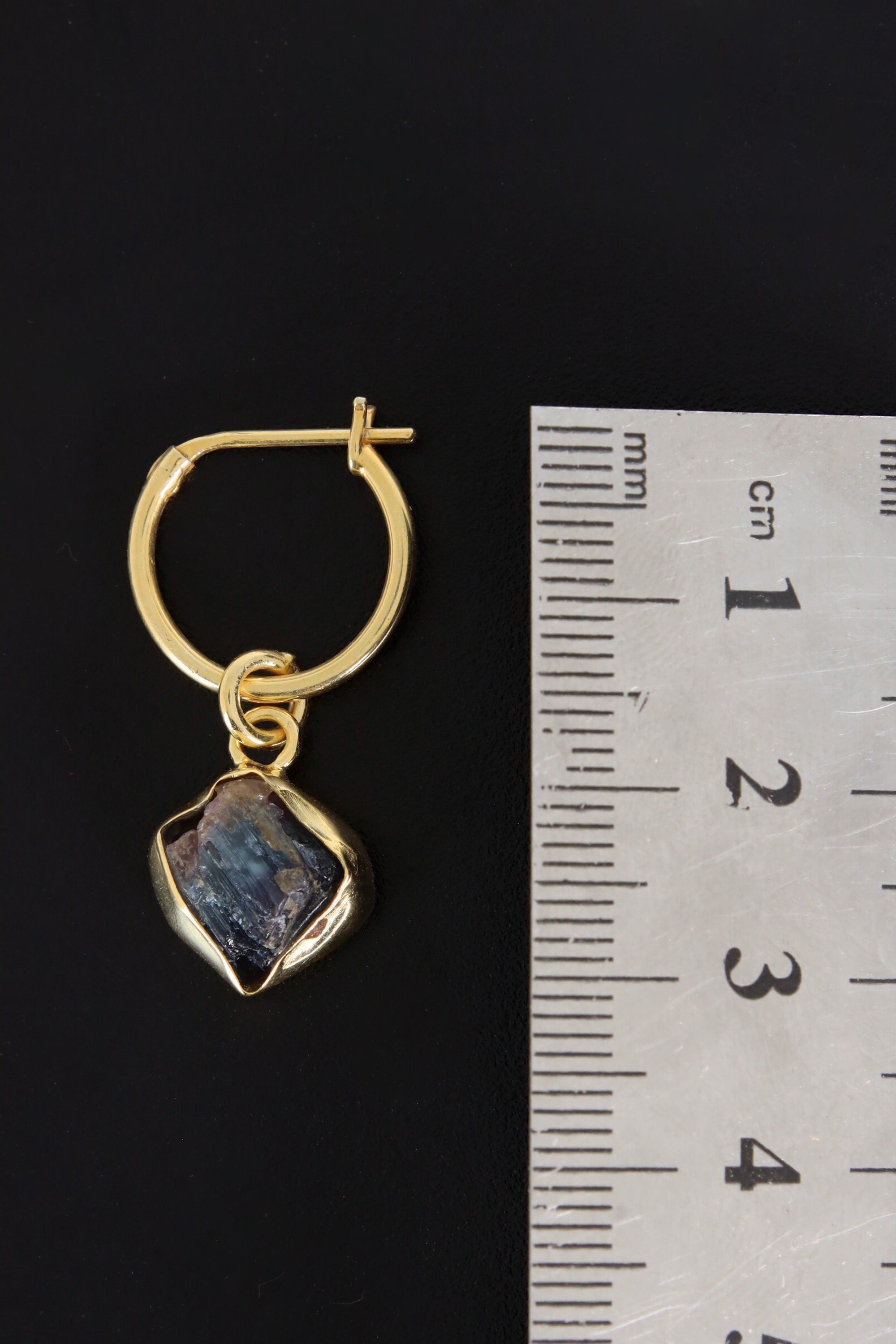 Rubellite Pink Tourmaline gold-plated hoop earring pendant shown beside a ruler for scale as one single piece.