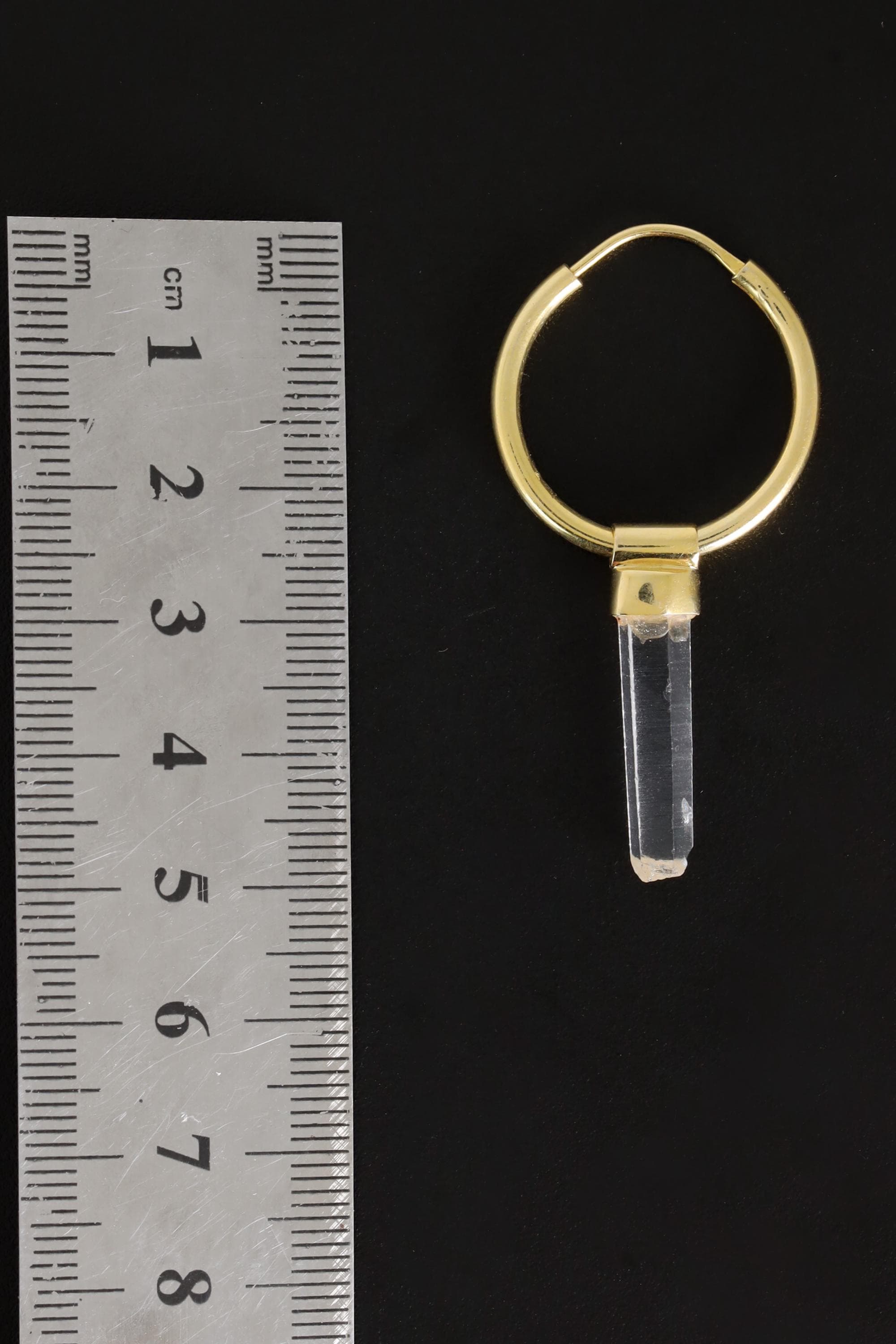 Clear Quartz gold-plated hoop earring pendant shown beside a ruler for scale as one single convertible piece.
