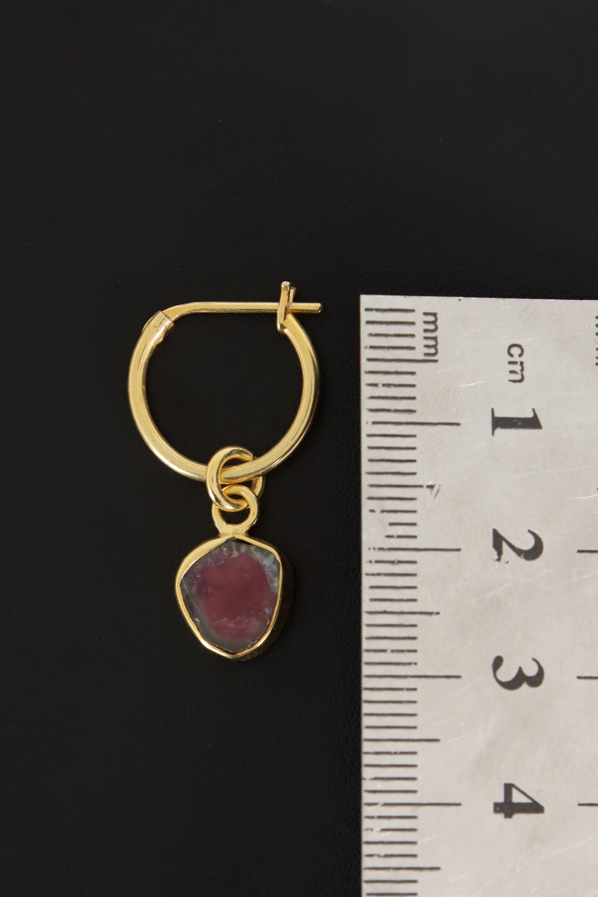 Watermelon Tourmaline gold-plated hoop earring pendant shown beside a ruler for scale as one single piece.