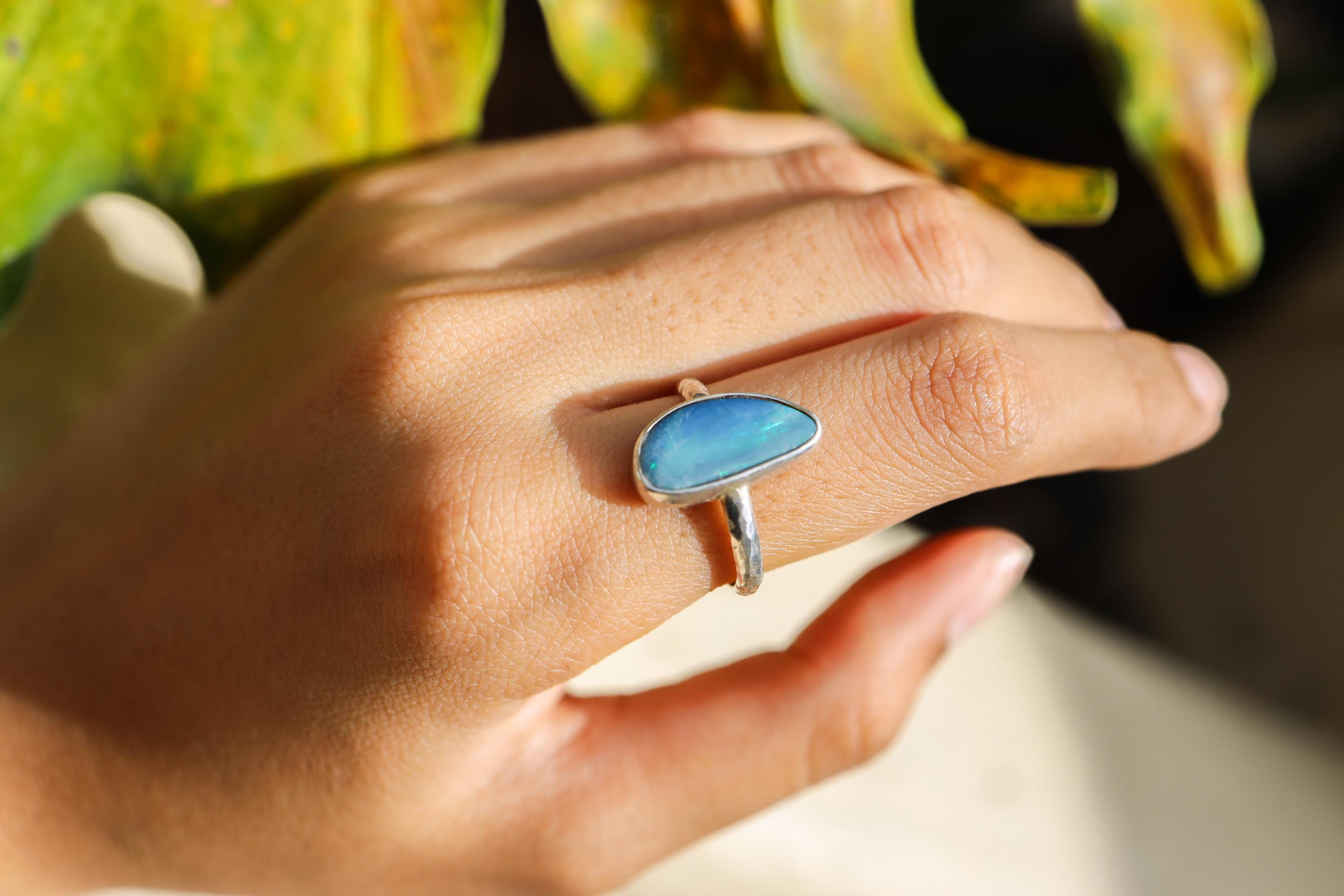 Precious Australian Opal Doublet Ring shown worn on hand with bright blue Opal and handmade silver setting.