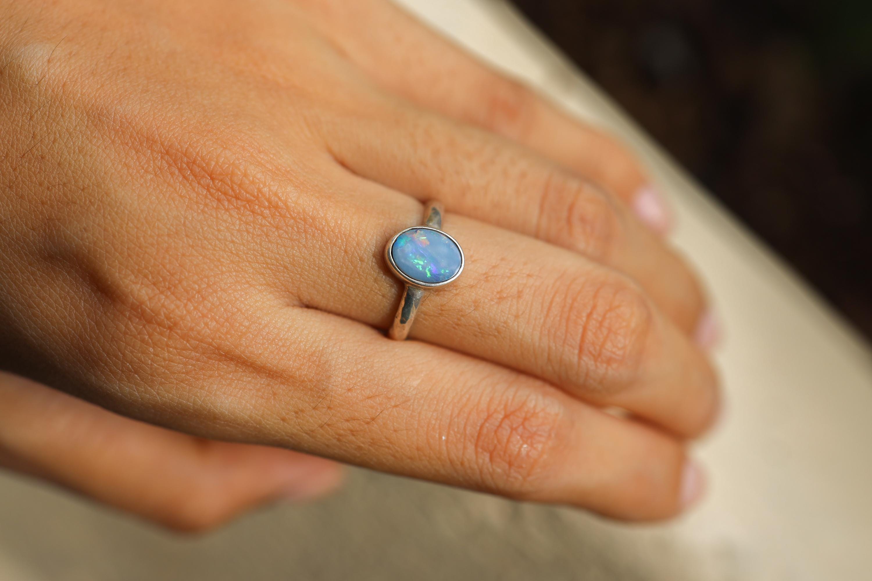 Precious Australian Opal Doublet Ring shown worn on hand with vivid blue Opal and textured sterling silver band.