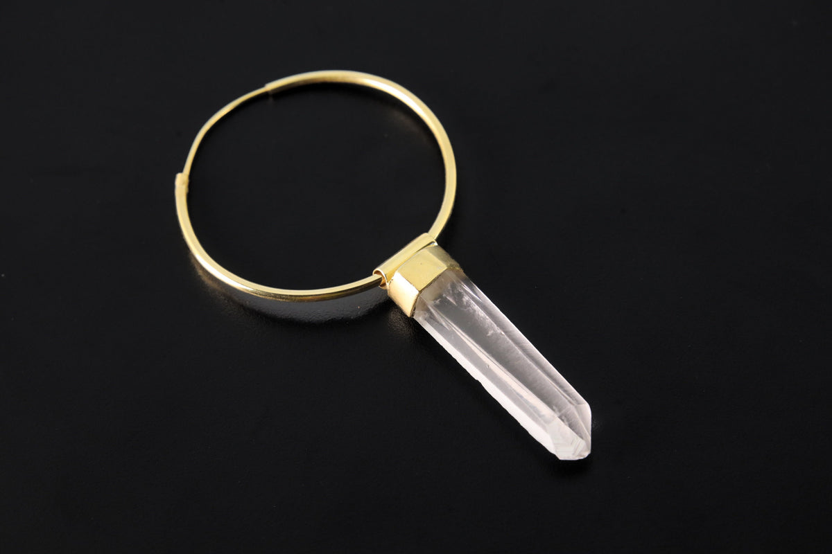 Lemurian Quartz gold-plated sterling silver dangle hoop earring shown on dark background with clear crystal point.