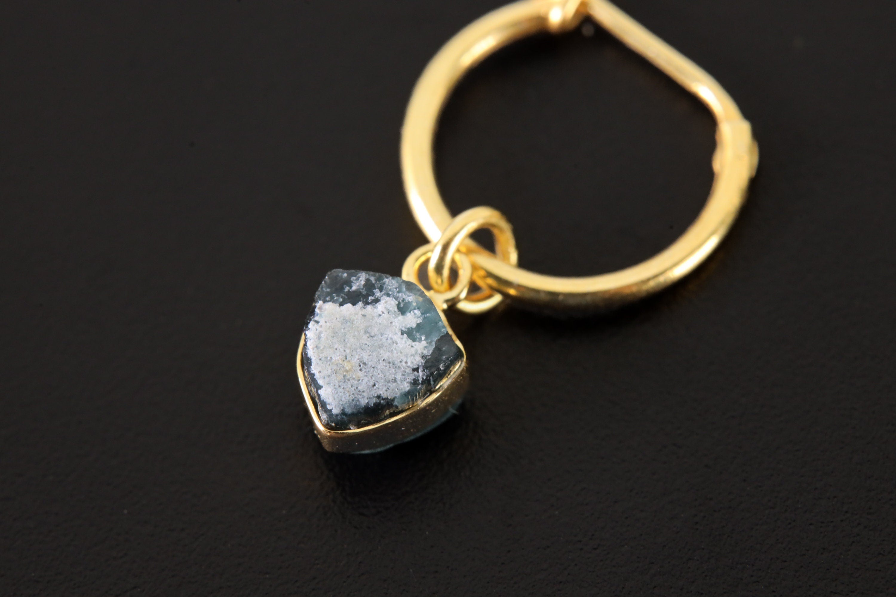 Golden Blue Tourmaline Whisper earring pendant shown close-up with prong-set Indicolite and warm gold hoop.