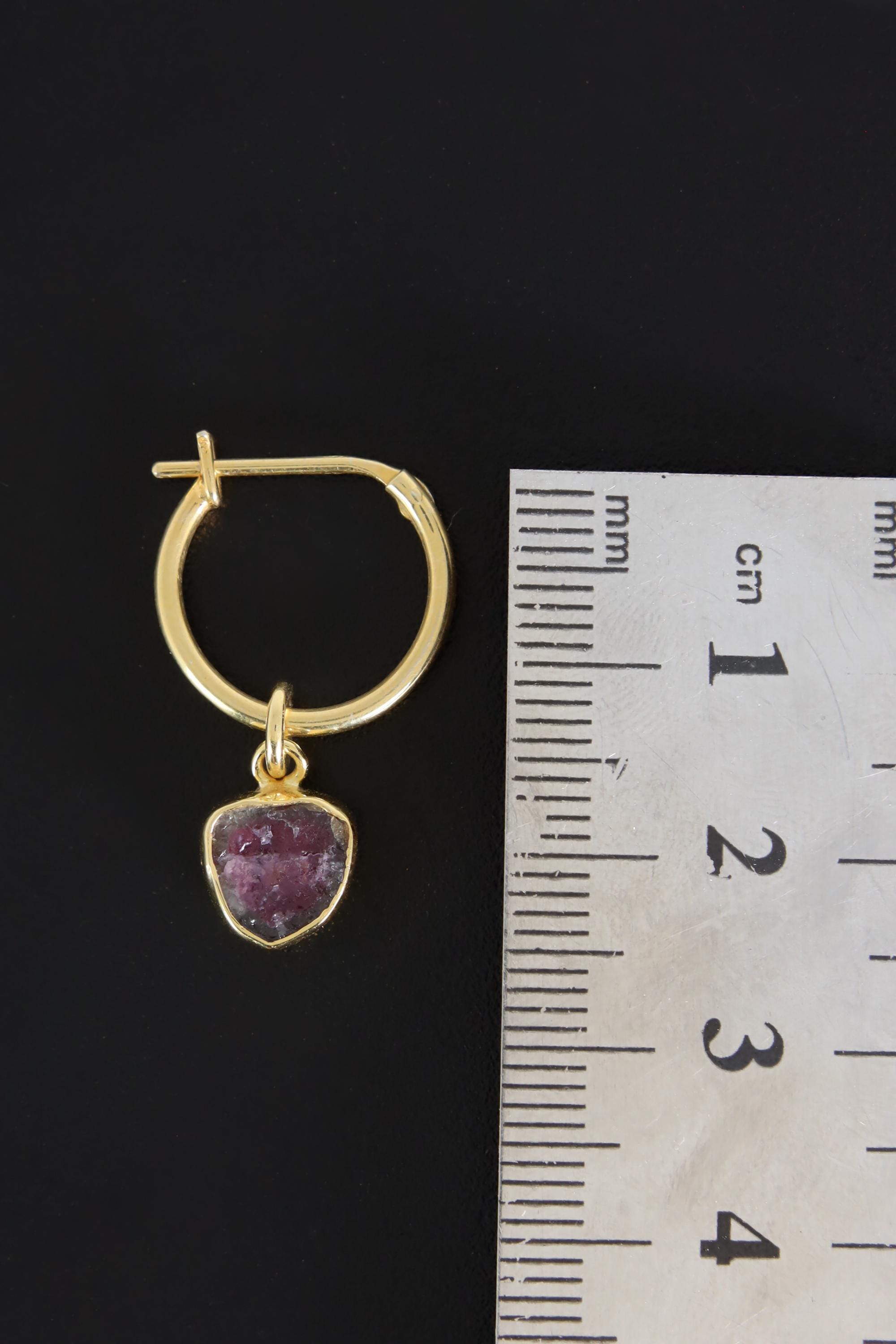 Watermelon Tourmaline gold-plated hoop earring pendant shown beside a ruler for scale as one single piece.