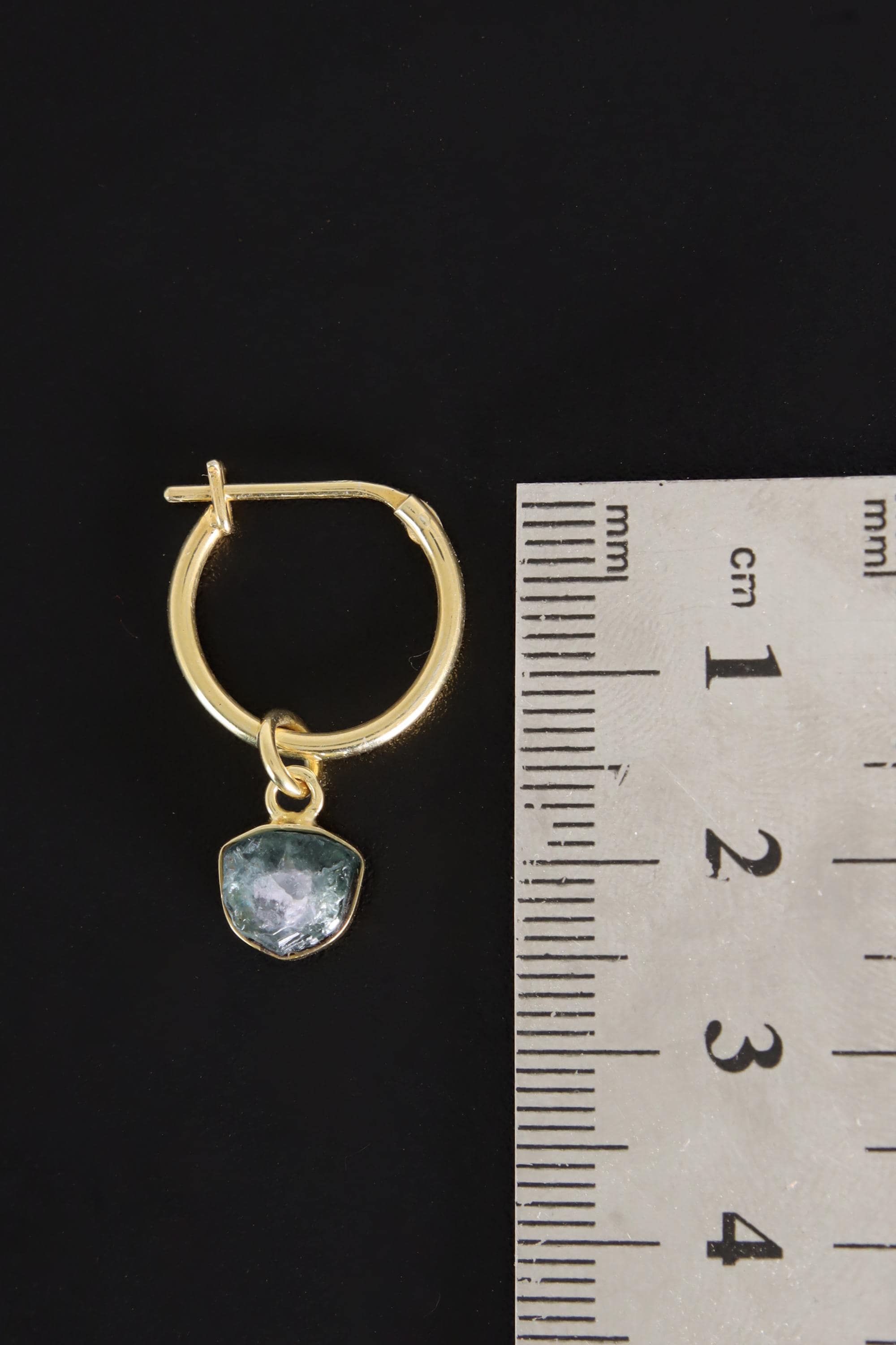Blue Tourmaline gold-plated hoop earring pendant shown beside a ruler for scale as one single piece.