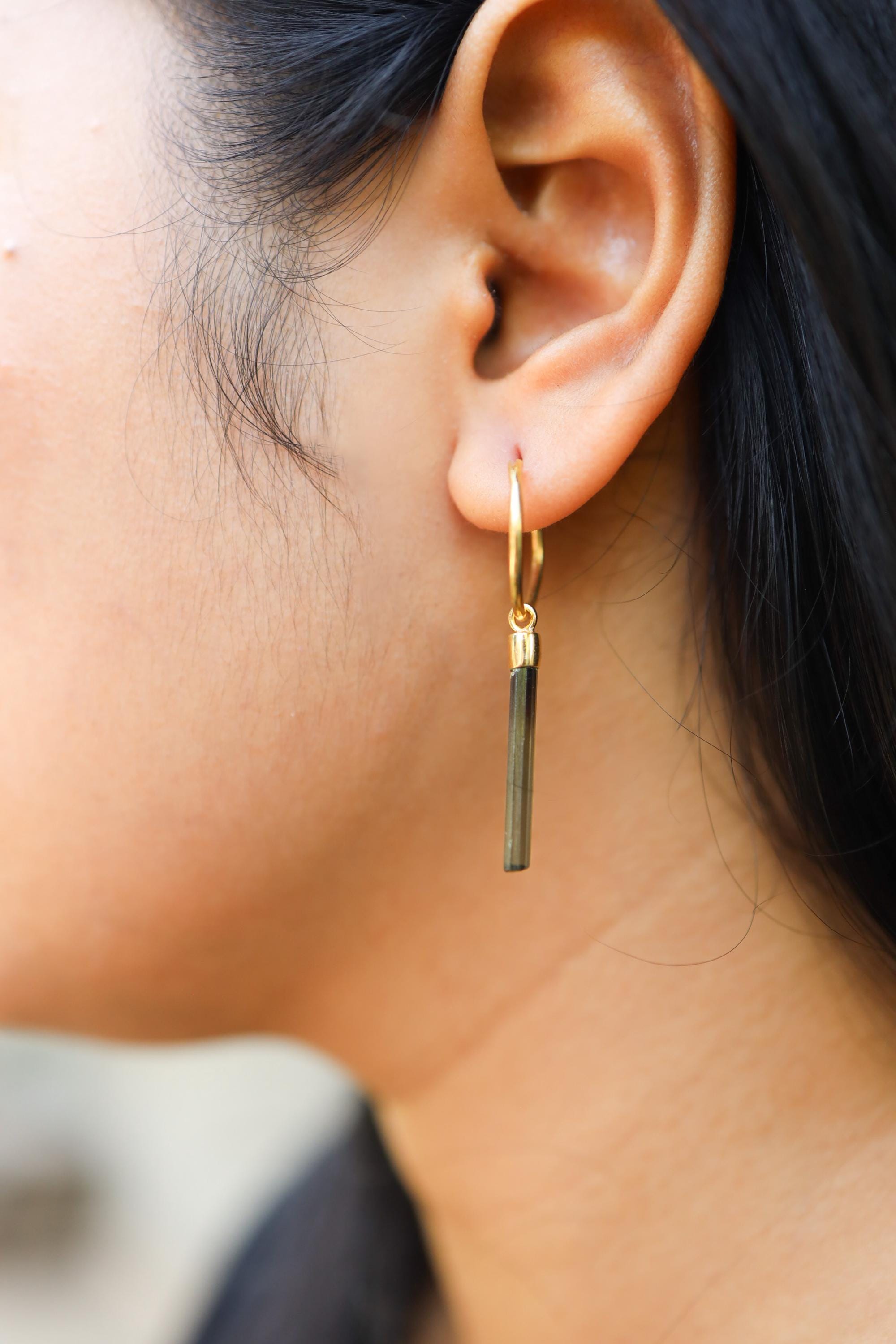 Green Tourmaline hook earring worn on a model, showing slim crystal drop and warm gold-plated silver.