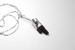 Himalayan Brown Dravite Tourmaline pendant on white background, showing dark terminated crystal and shiny sterling silver cap.