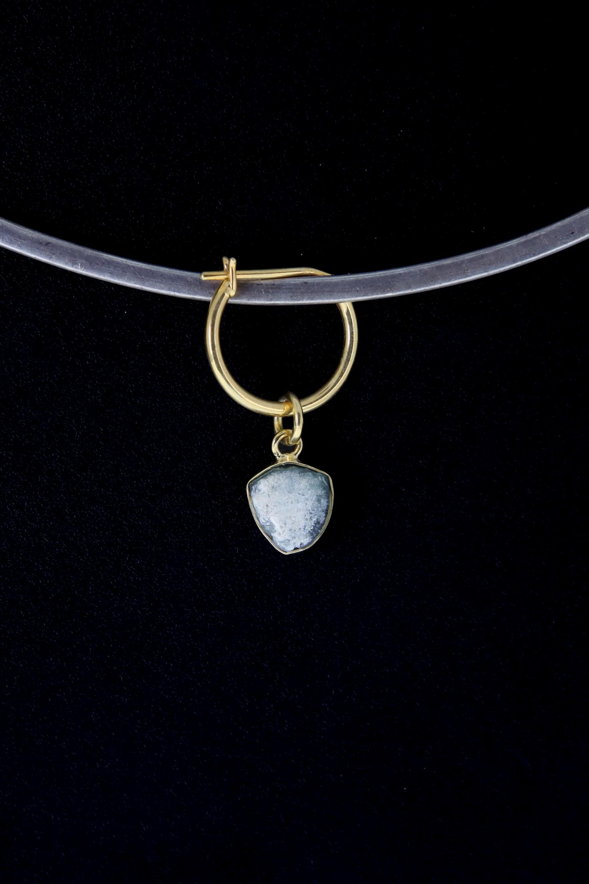 Single Blue Tourmaline hoop earring shown on a dark background with gold-plated silver and raw crystal slice.