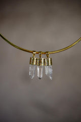 Small Clear Quartz point pendants on a gold-toned choker, with 18k gold-plated caps and natural crystal wand shapes.