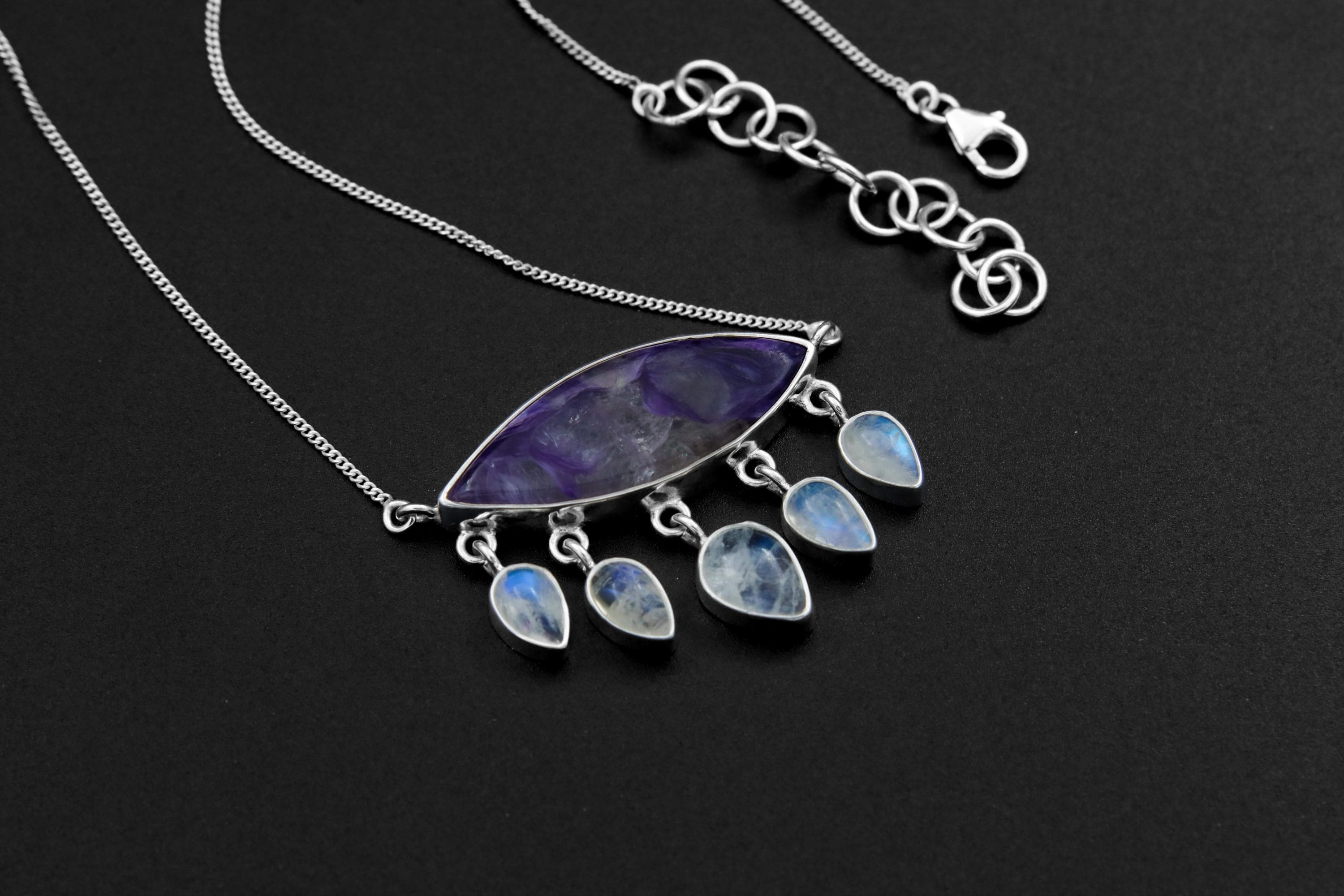Charoite Blue Moonstone eye necklace in high-shine 925 sterling silver with purple centre stone and five teardrop Moonstone dangles.