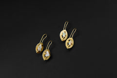 White Opal halo earrings shown as a matching pair, with gold-plated sterling silver hooks and pale luminous stones.
