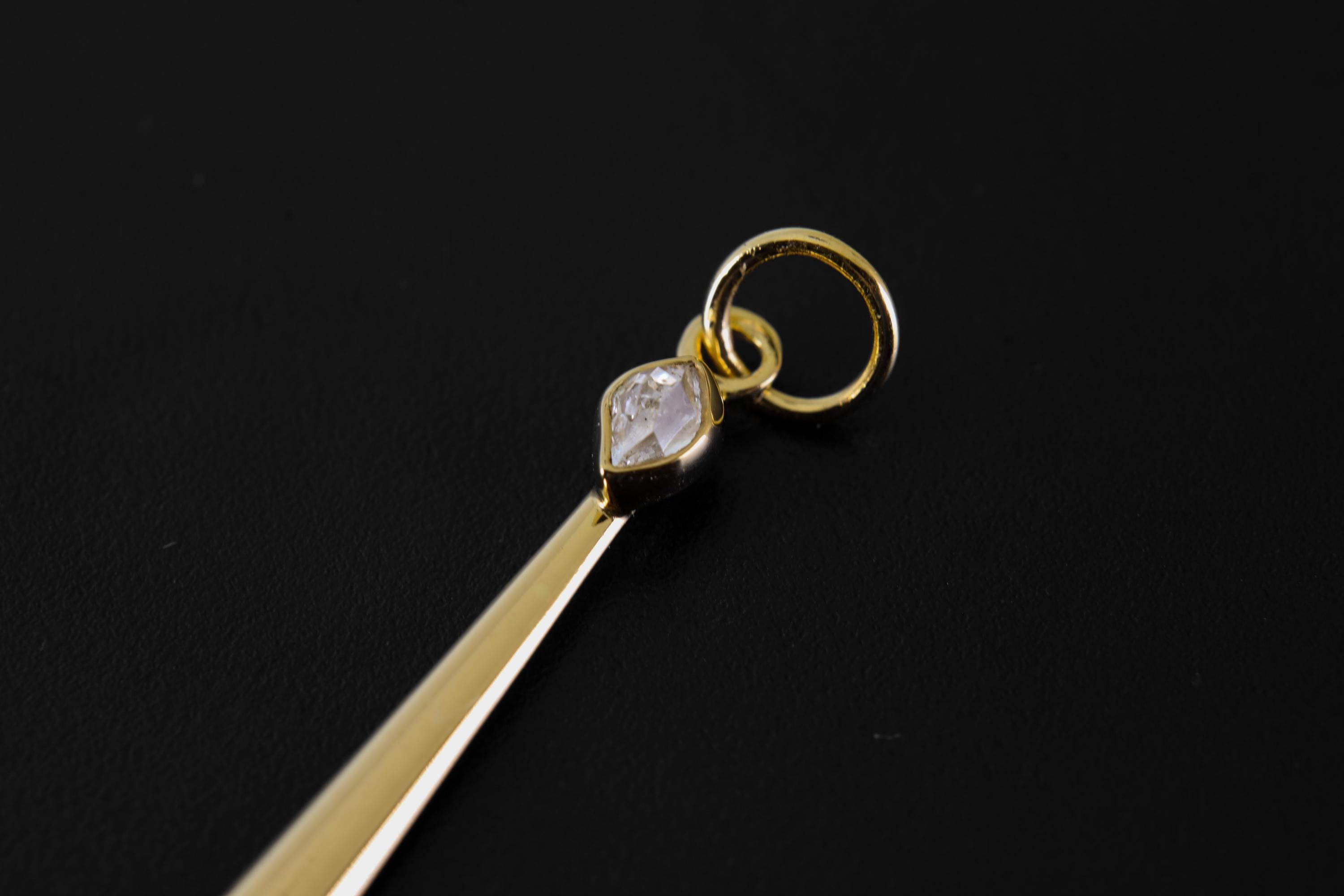 Close-up of Herkimer Diamond set at the top of a gold-plated ceremonial spoon pendant.