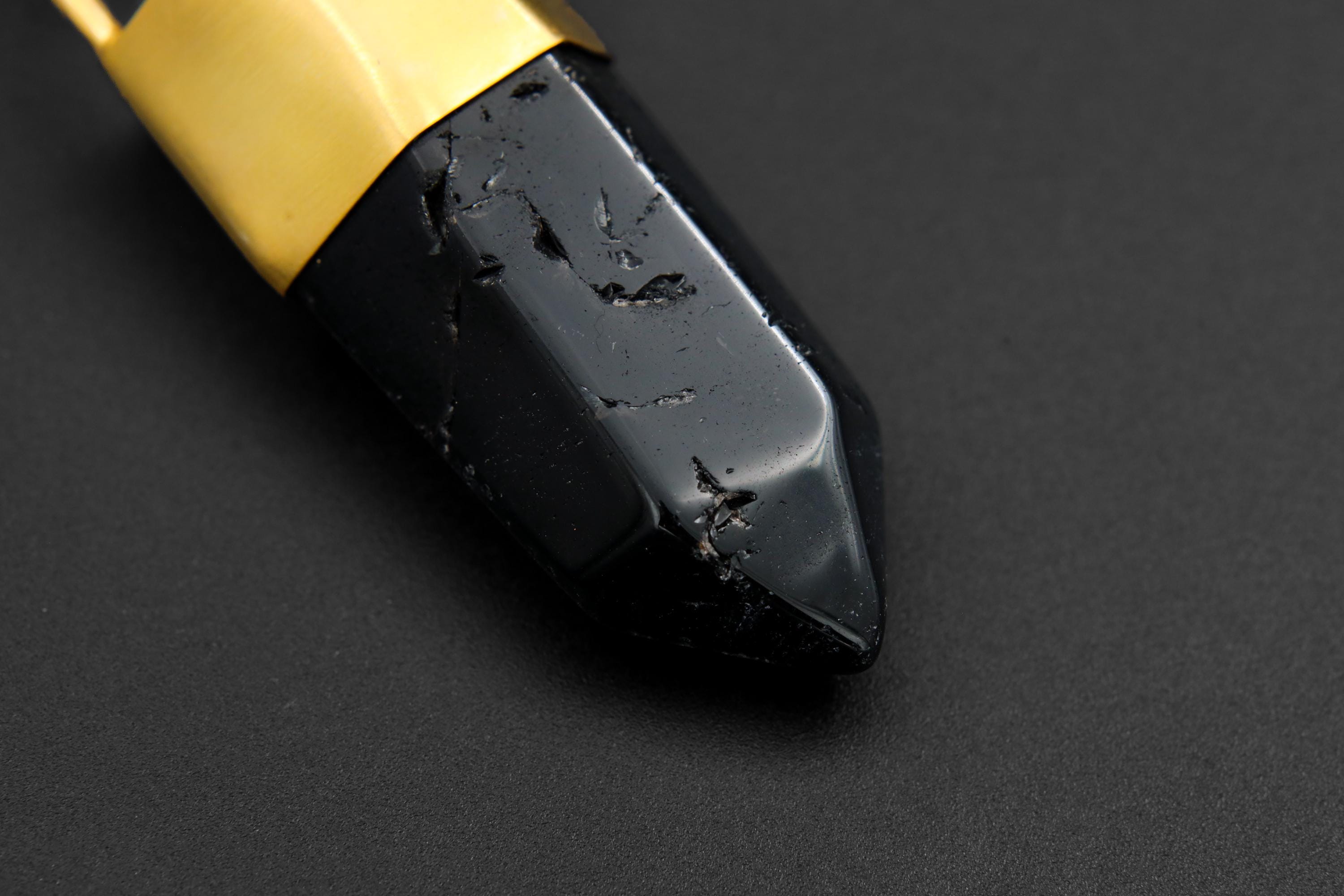Detail of 18k gold-plated bronze cap and triple bail on a large dark Smoky Quartz crystal point pendant.